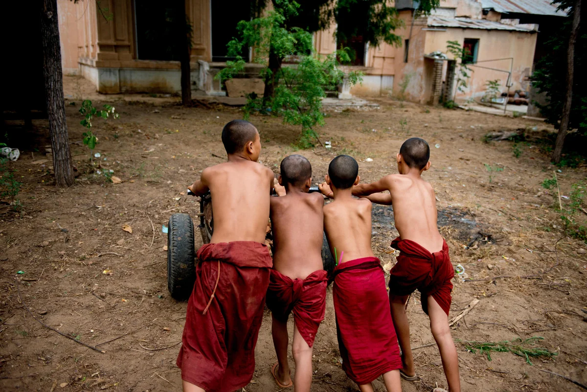  Group of novice monks help build new facilities at a small monastery in Bagan. 
