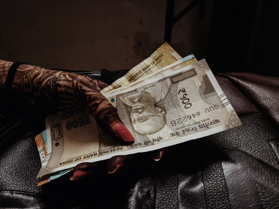 Henna-Decorated Hands Holding Money.png
