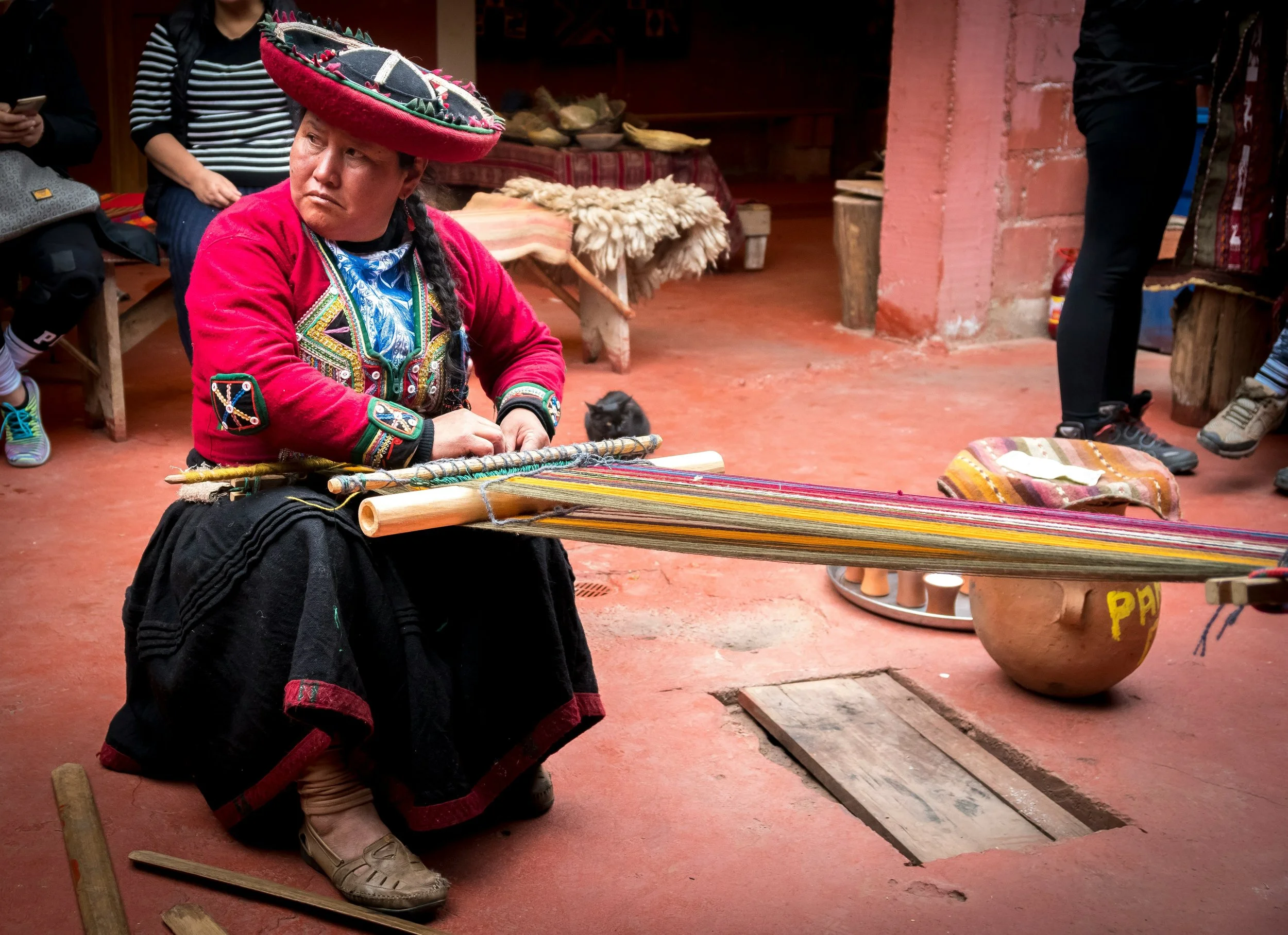 A local woman in Chinchero demonstrates traditional weaving techniques.