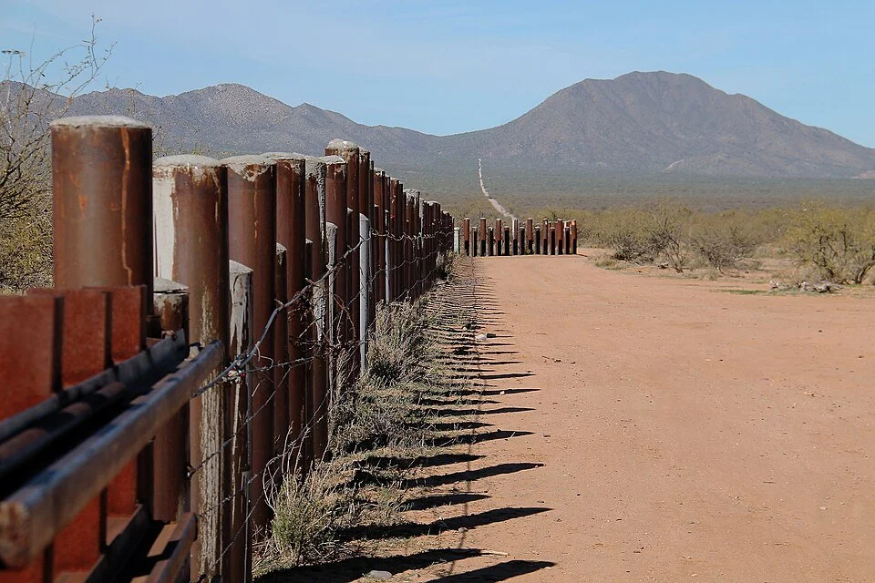 Border barrier infrastructure runs along the desert landscape on Tohono O’odham Nation land.