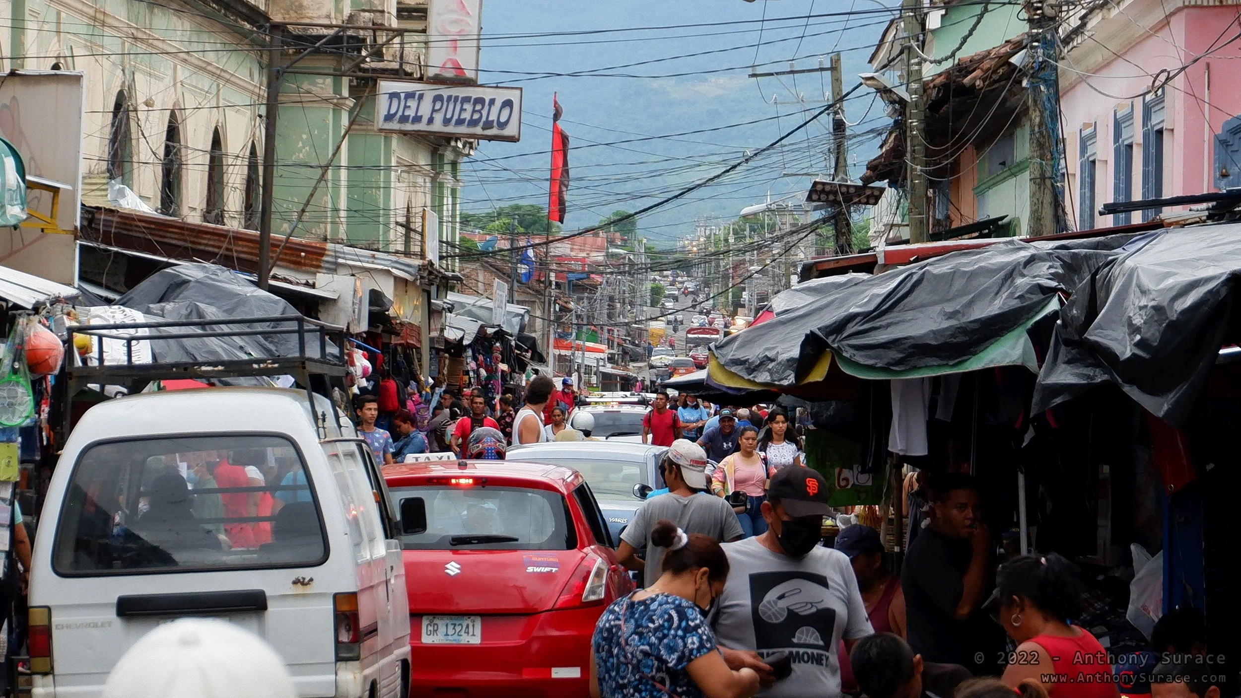 Crowded street with people and cars