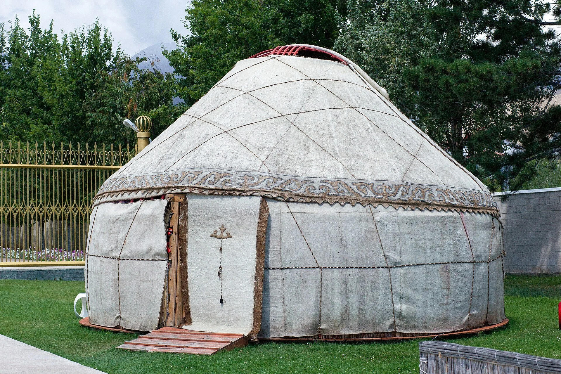 Kyrgyz yurt surrounded by mountains in Kyrgyzstan.