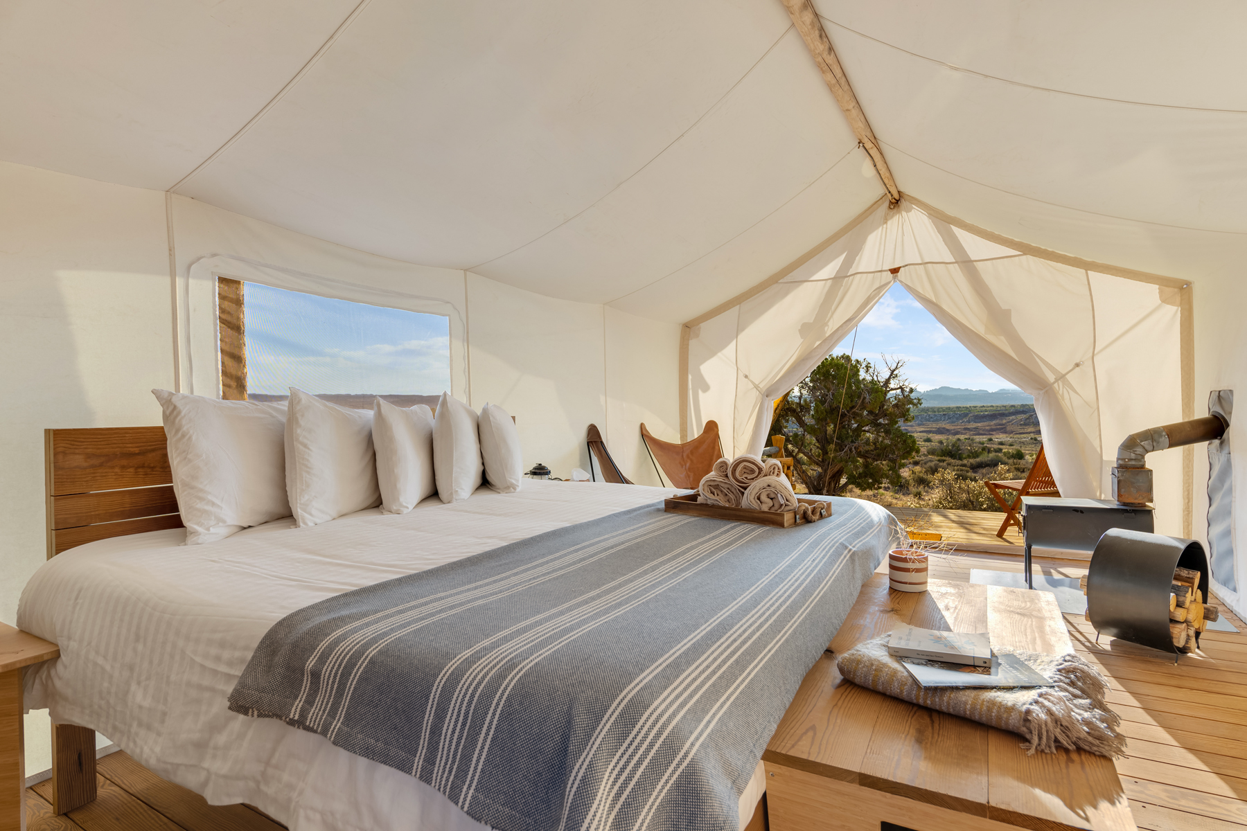 Suite Tent with a lounge area and a scenic desert landscape deck. Courtesy of Under Canvas Moab.