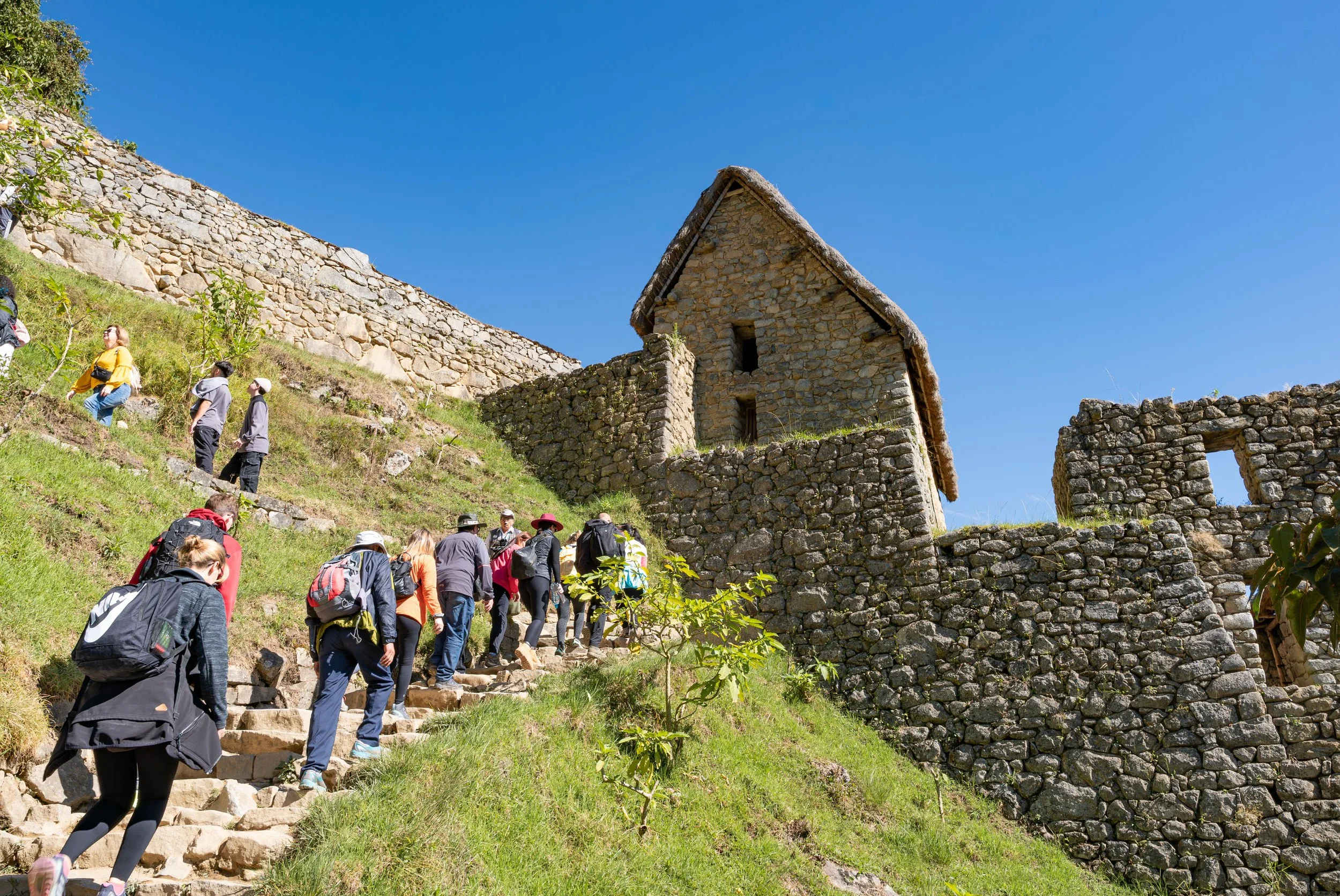 Tourists walking through the ruins of Machu Picchu, which today is divided into multiple circuits