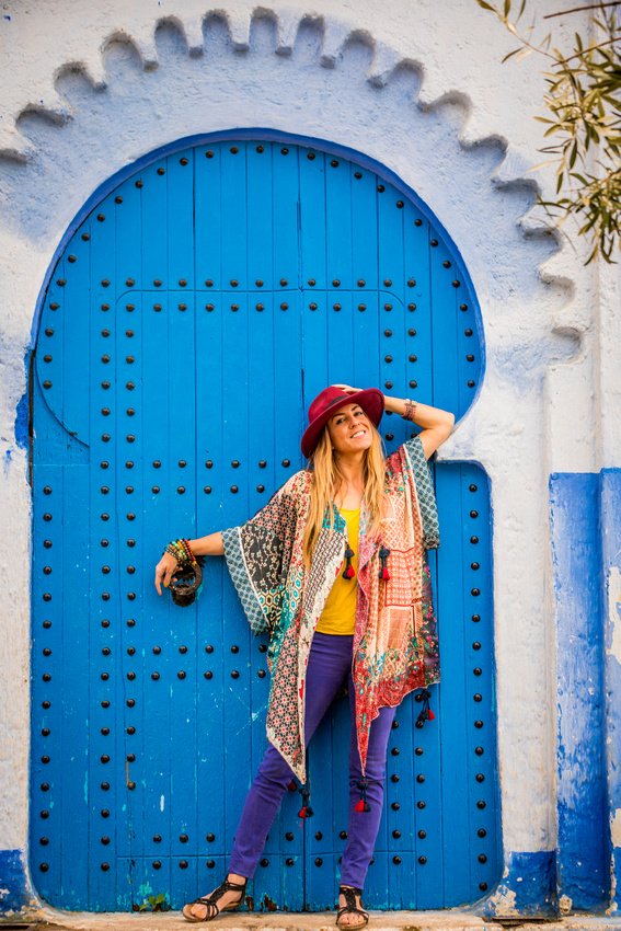 Laura standing in front of a blue door