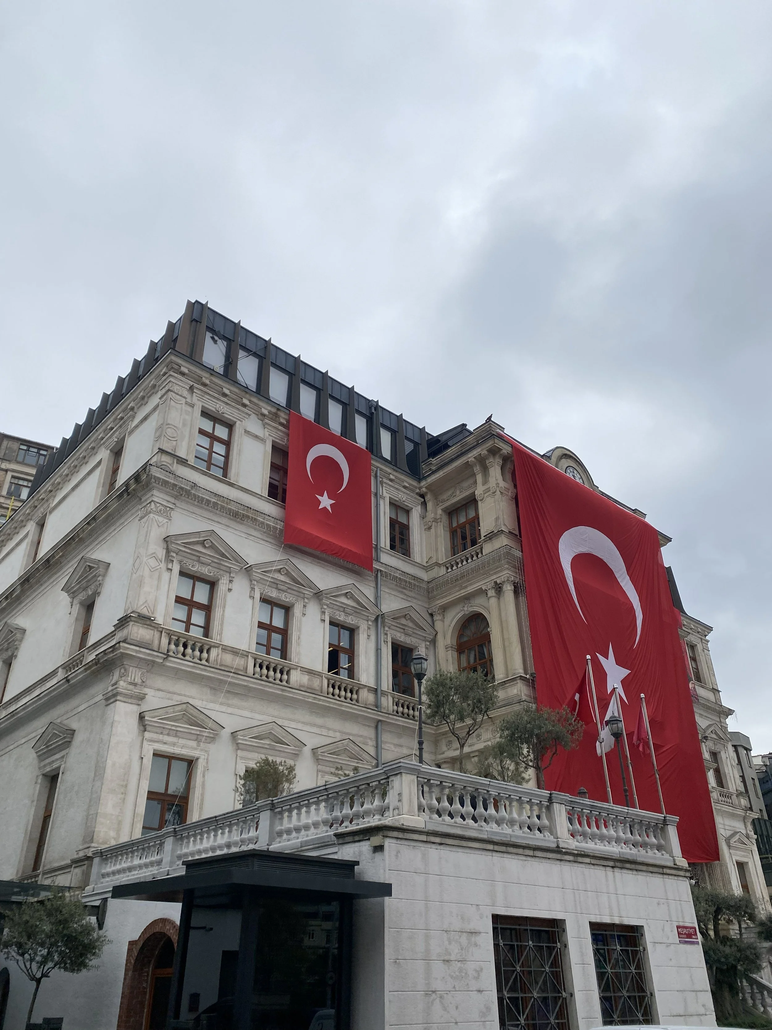 A Turkish flag displayed on a historic building in Istanbul, Turkiye.