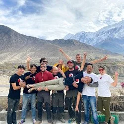 The Follow Alice team in Nepal take a picture with the Himalayas behind them.
