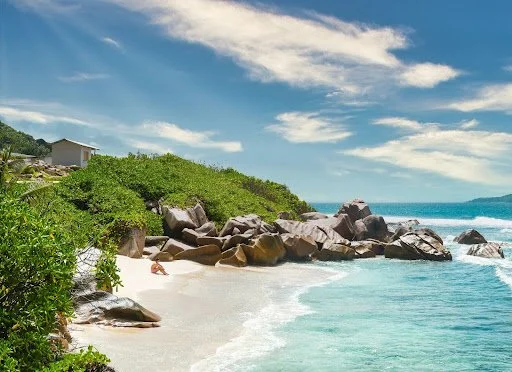 White sand beach with rocks and boulders