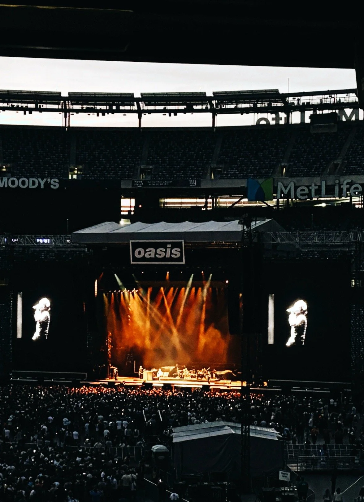 Oasis performing on stage during a concert at MetLife Stadium in New York City.