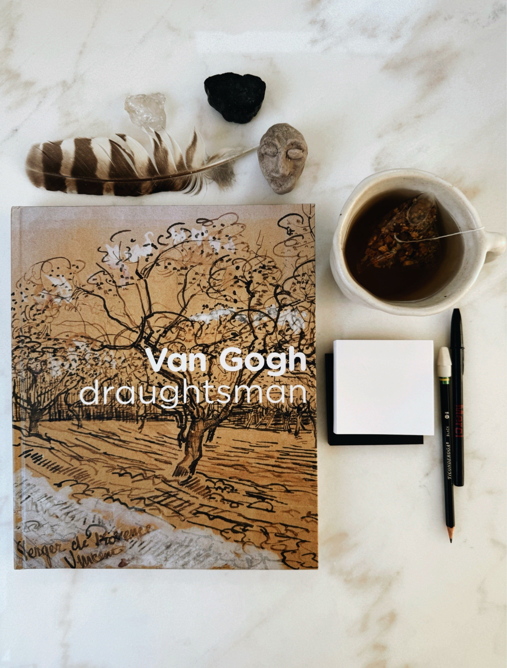 Van Gogh: The Draughtsman exhibition catalog from the Vincent Van Gogh Museum on studio table.
