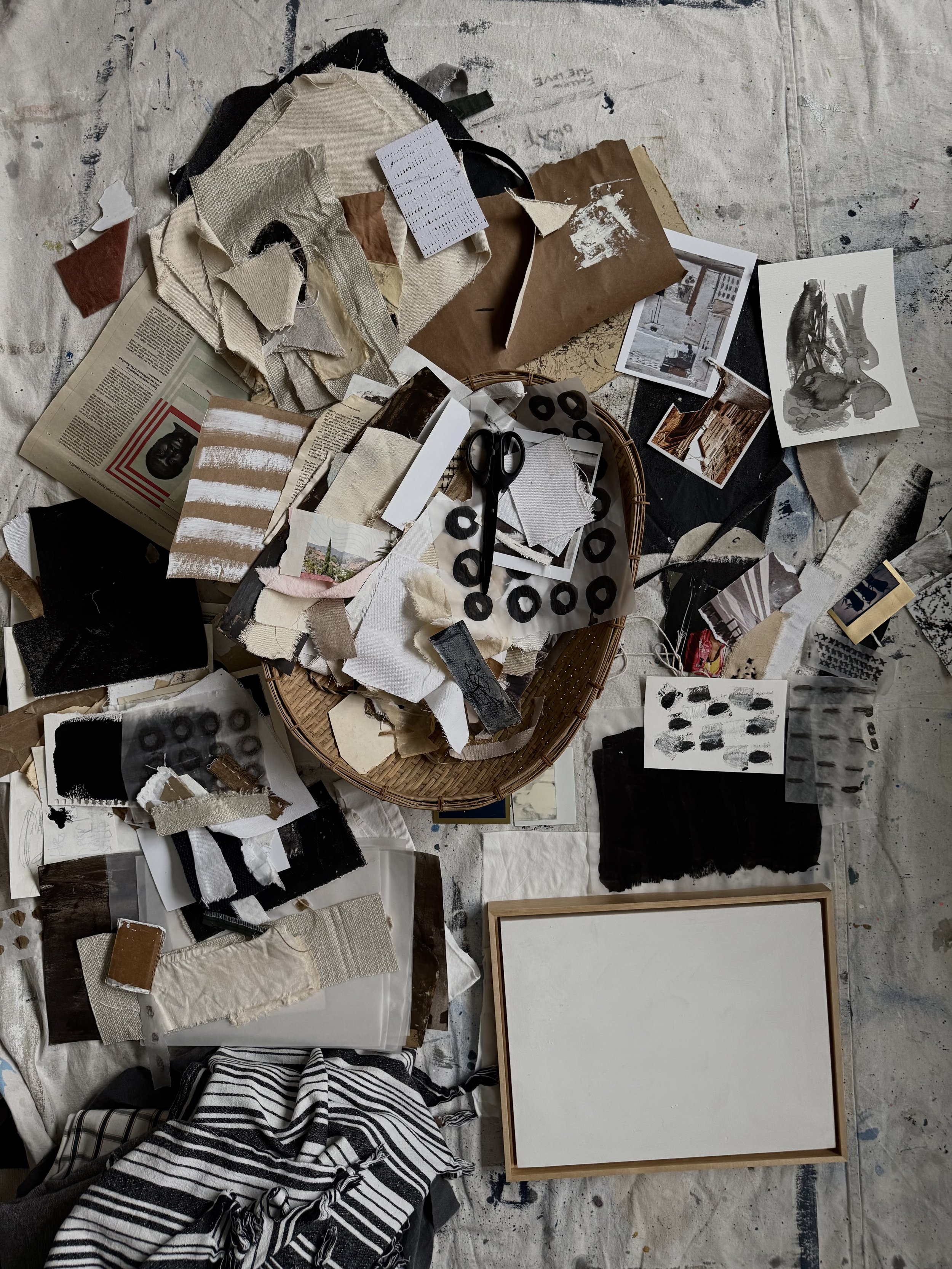 Colage art supplies on studio floor.