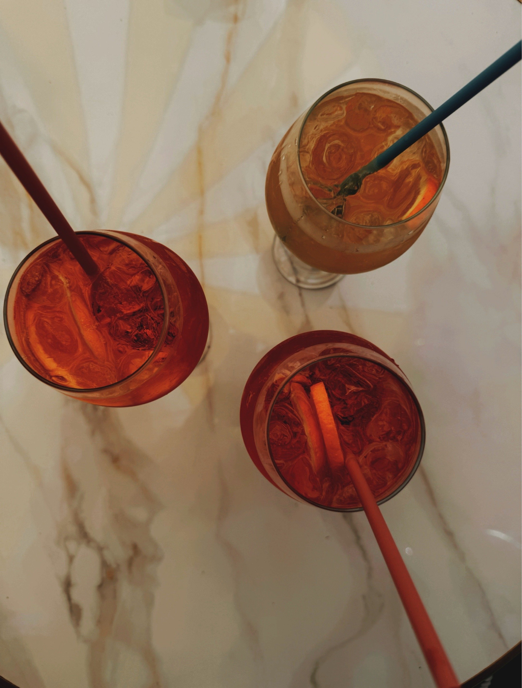 Aperol spritz cocktails at Bev Proseccheria in Charlotte NC with citrus garnish and summer light.