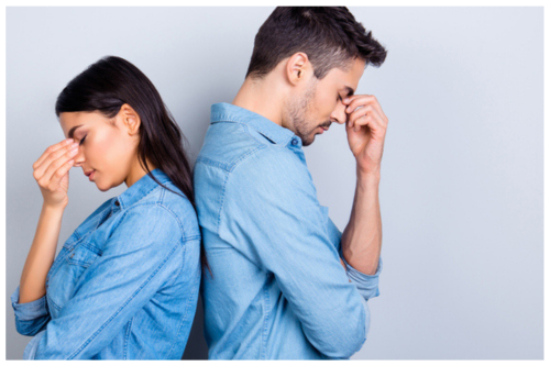 man and woman in relationship disagreement with tension looking down