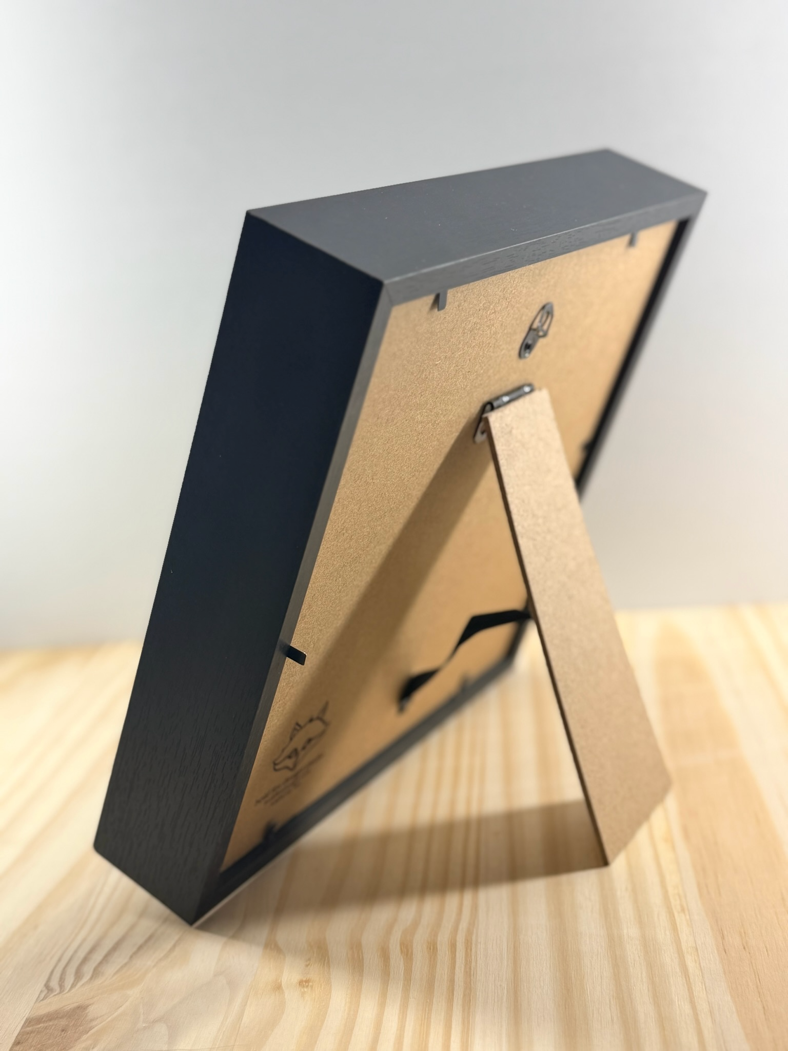 Back of shadow boxes with etched logo