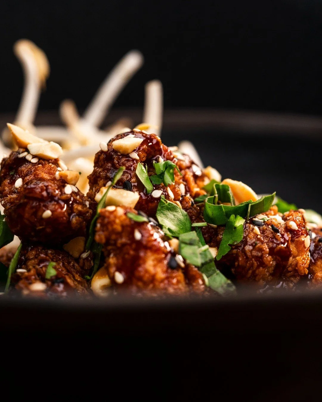 Grab your chopsticks, this sticky Thai chicken deserves every bite! 🥢🍗

Sticky Thai Chicken: Crispy ginger chicken, sweet &amp; spicy glaze, peanuts, thai basil, cilantro.