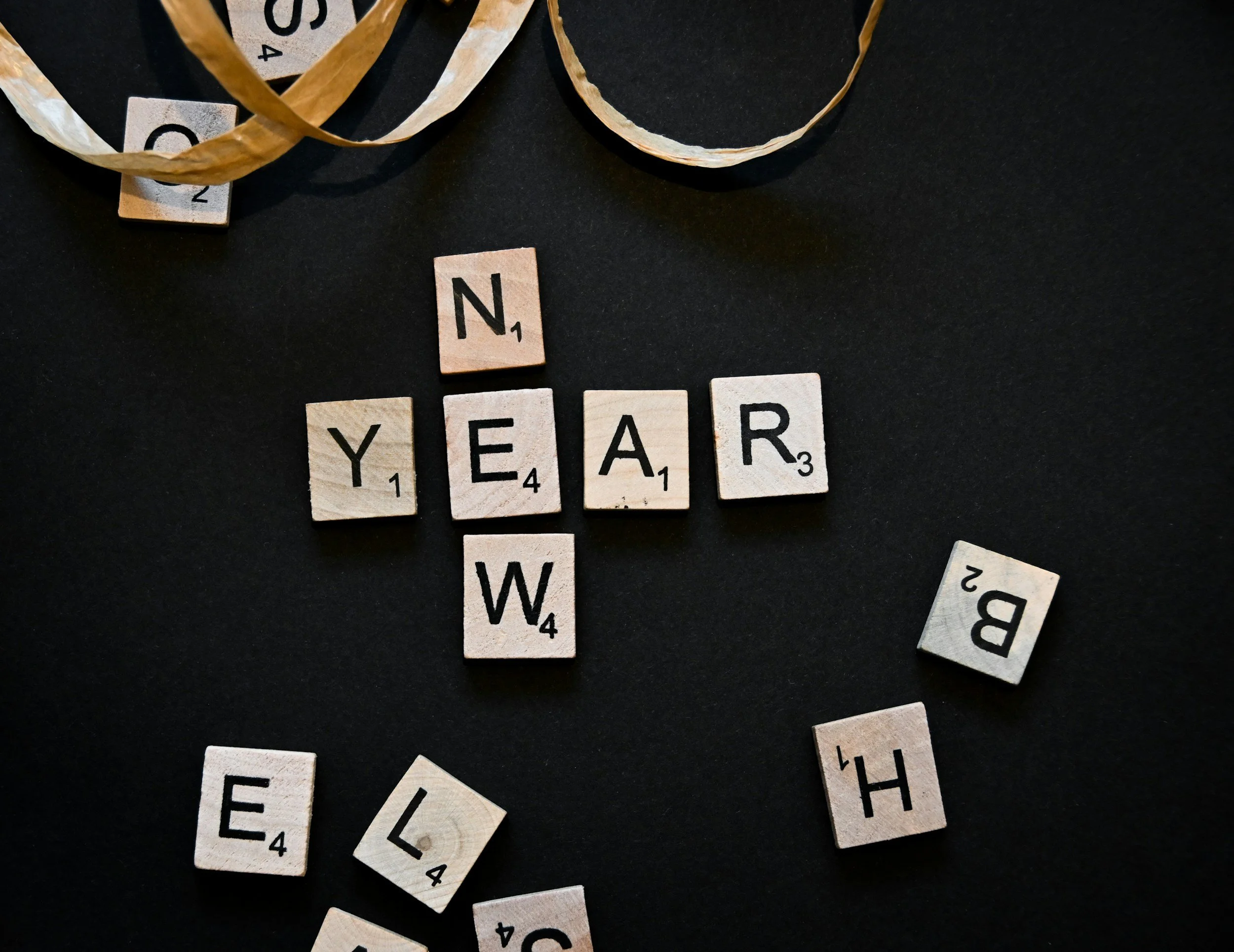 scrabble tiles reading "new year"