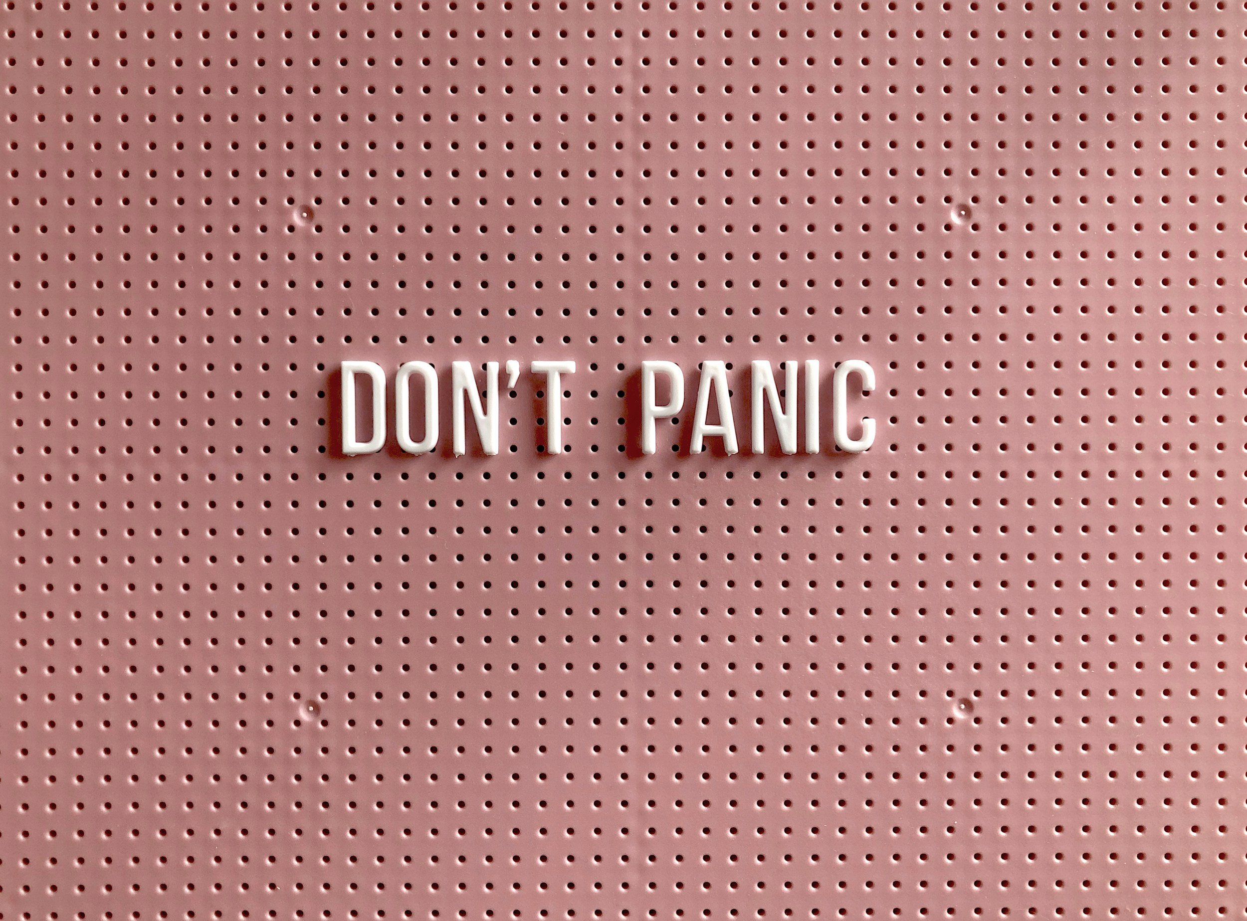 a peg board with the words don't panic on it