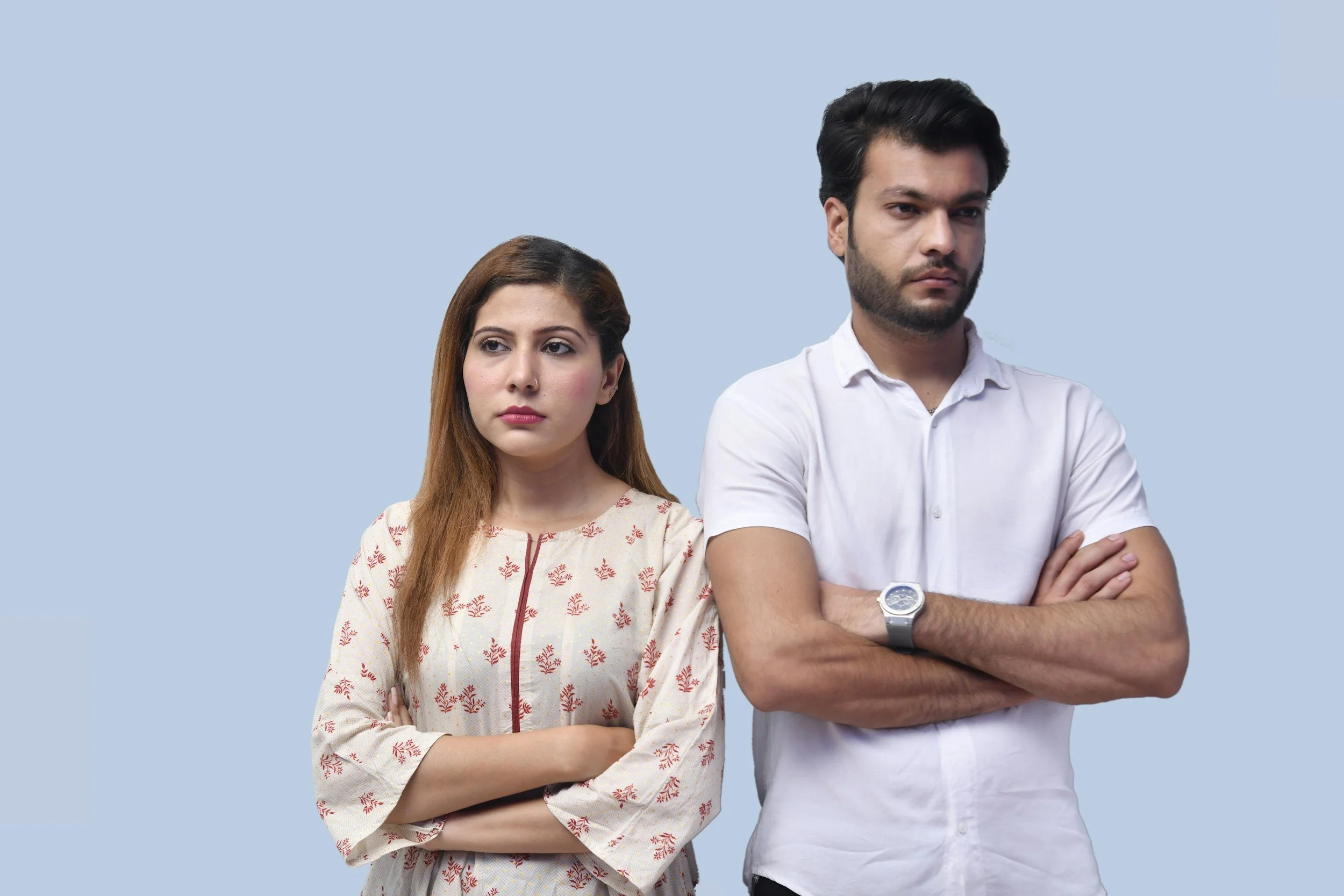 couple standing next to each other and they don't seem happy with each other