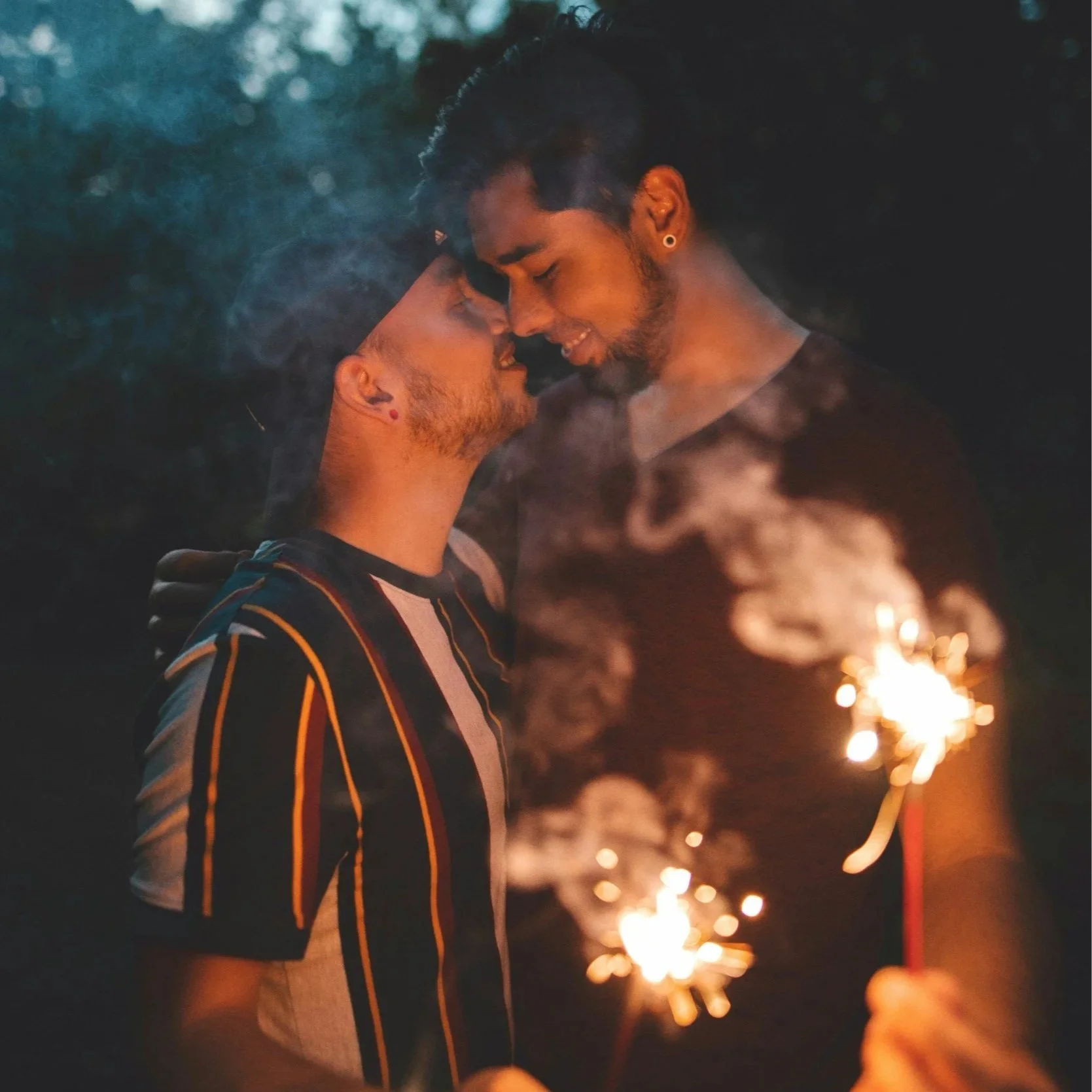 gay couple holding sparklers