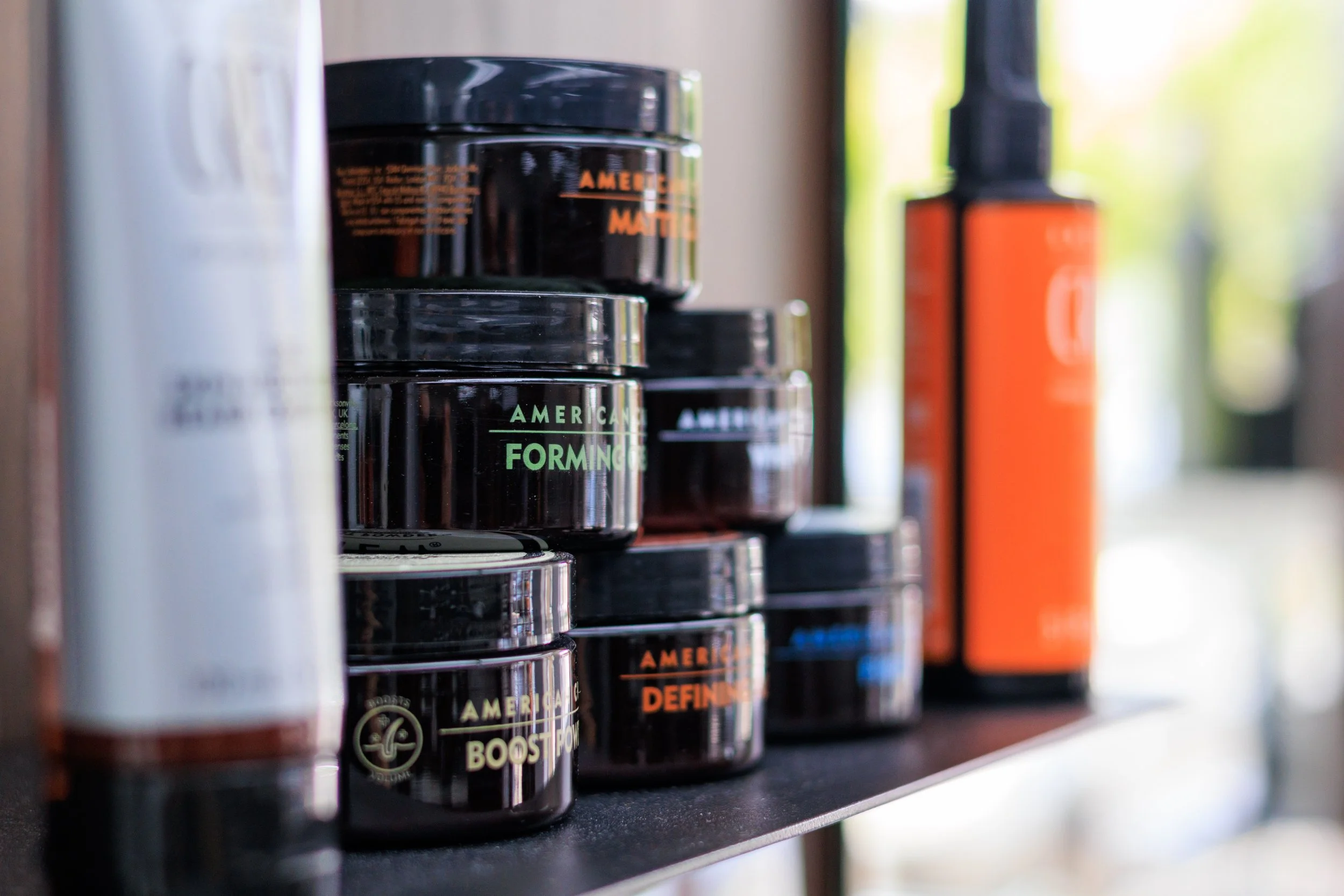 A Display of American Crew Hair Styling products and Skin Moisturiser