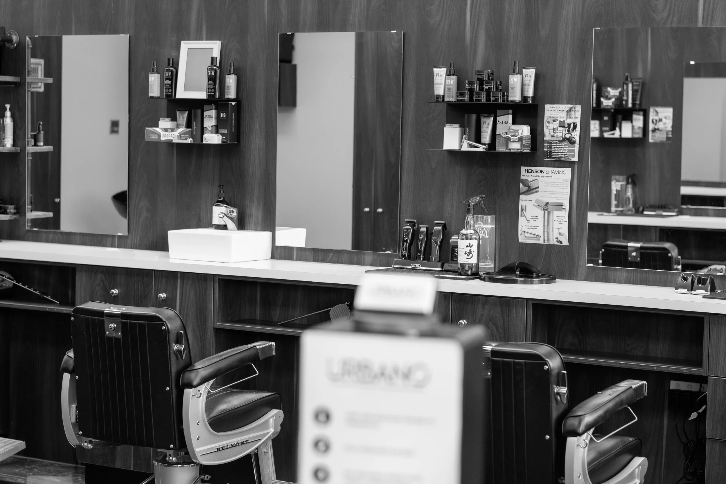 URBANO’s barbershop cutting stations in a clean maner with a display hair, skin and styling products. A range of Wahl clippers and equipment on top of the cutting benches with Takara Belmont Barber Chairs