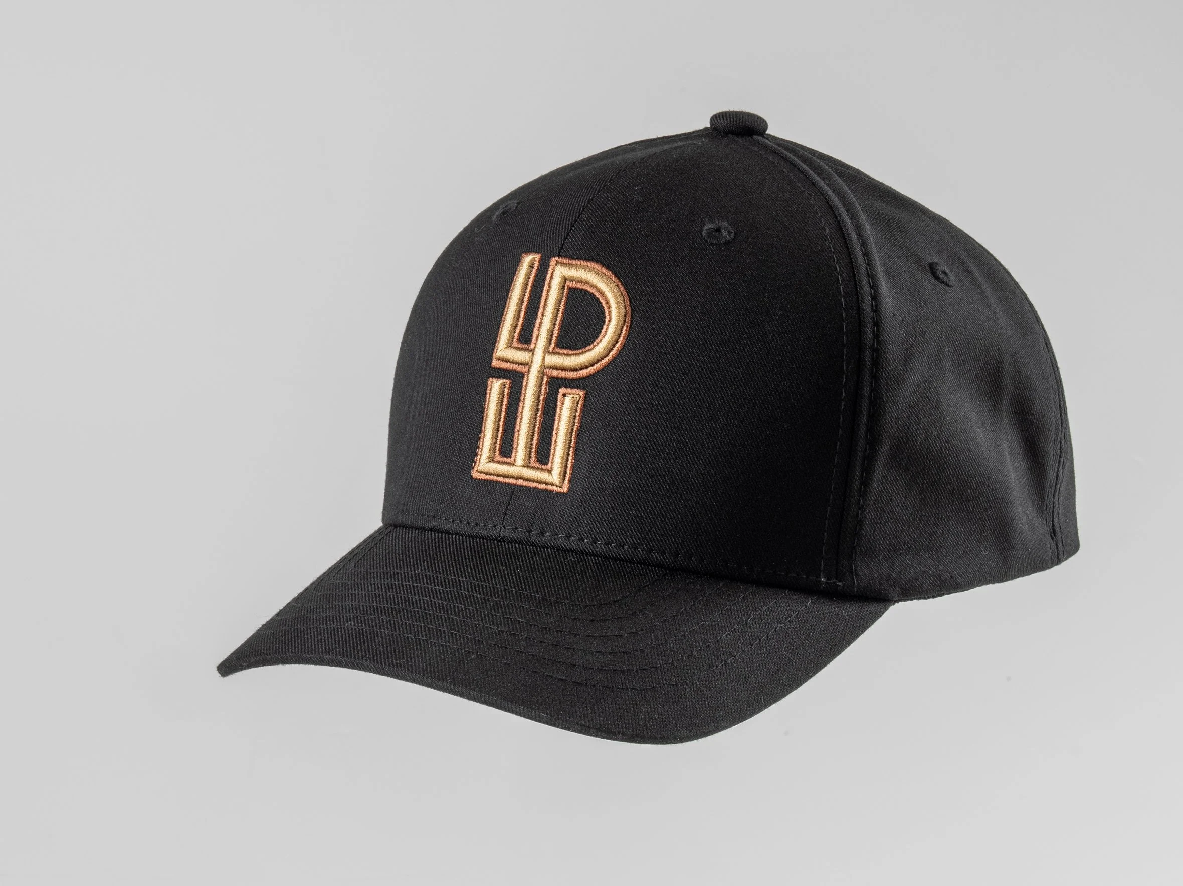 Black baseball cap with embroidered initials in gold, LPU, on the front.