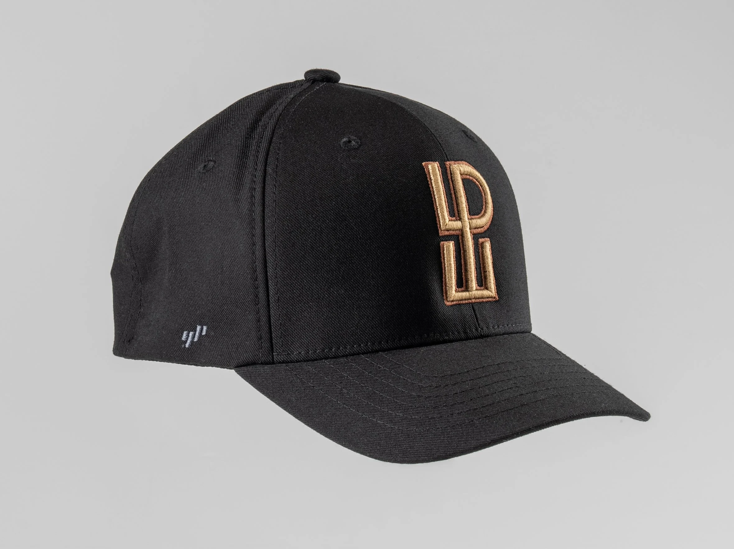 Black baseball cap with embroidered gold and beige 'LPL' logo on front, small white logo on left side, against a plain gray background.