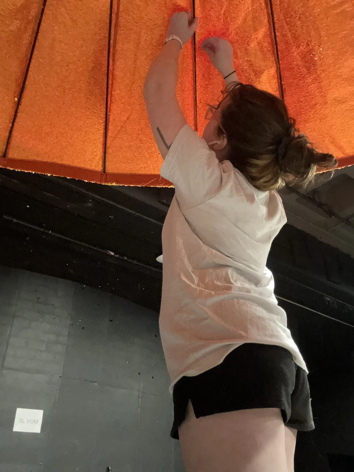 Each of the giant oranges for Love For Three Oranges was a giant umbrella with a large sequin cover. I applied and sewed down the cover to each spine and fitted the leaf to each. (Love for Three Oranges, DMMO '23)