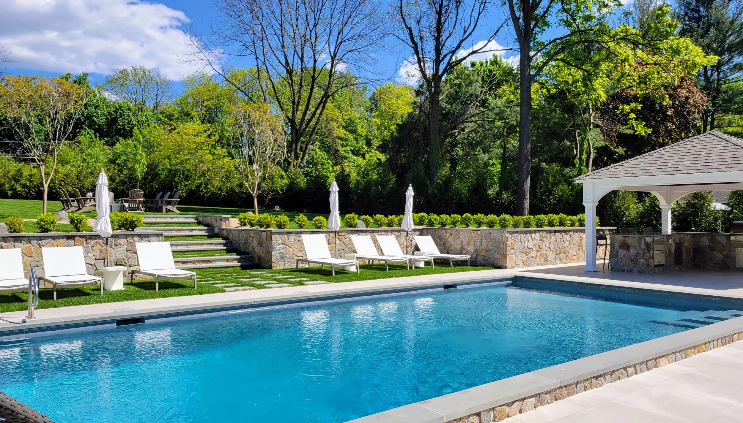 Sands Point pool patio with stone wall.