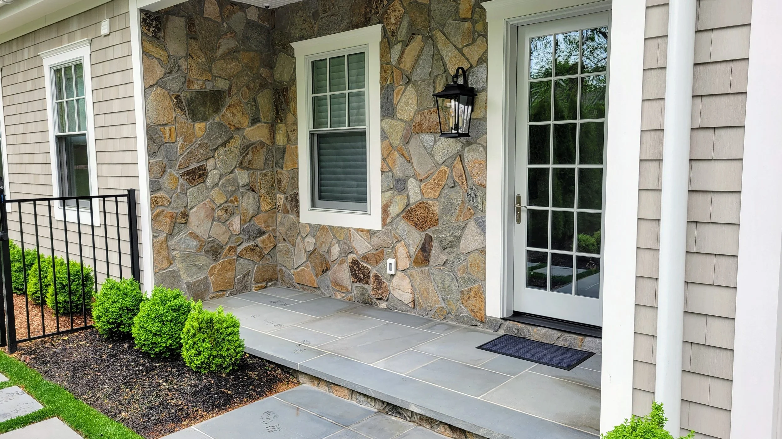 Stone installation on house side entryway.