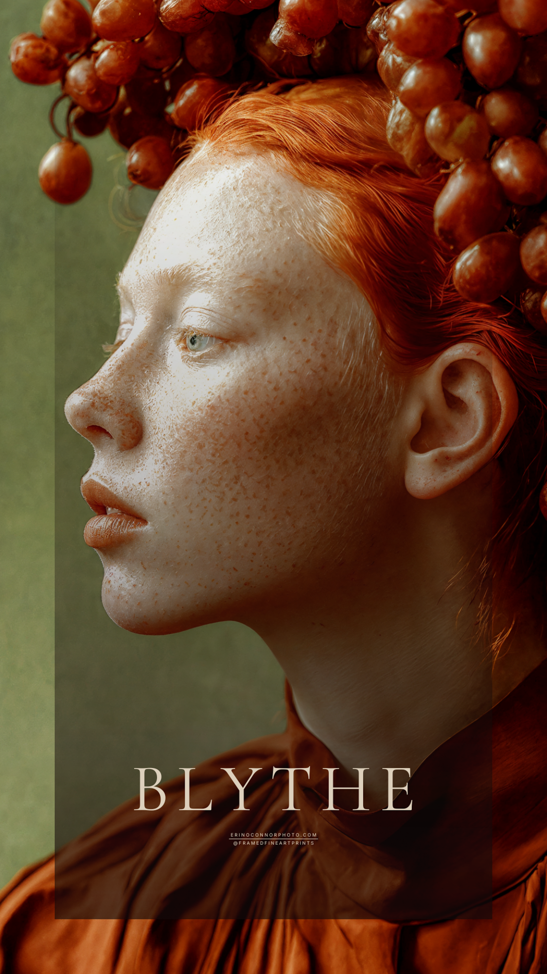 Close profile portrait of Blythe with pale freckled skin, red hair and an elaborate crown of red grapes and translucent amber leaves.