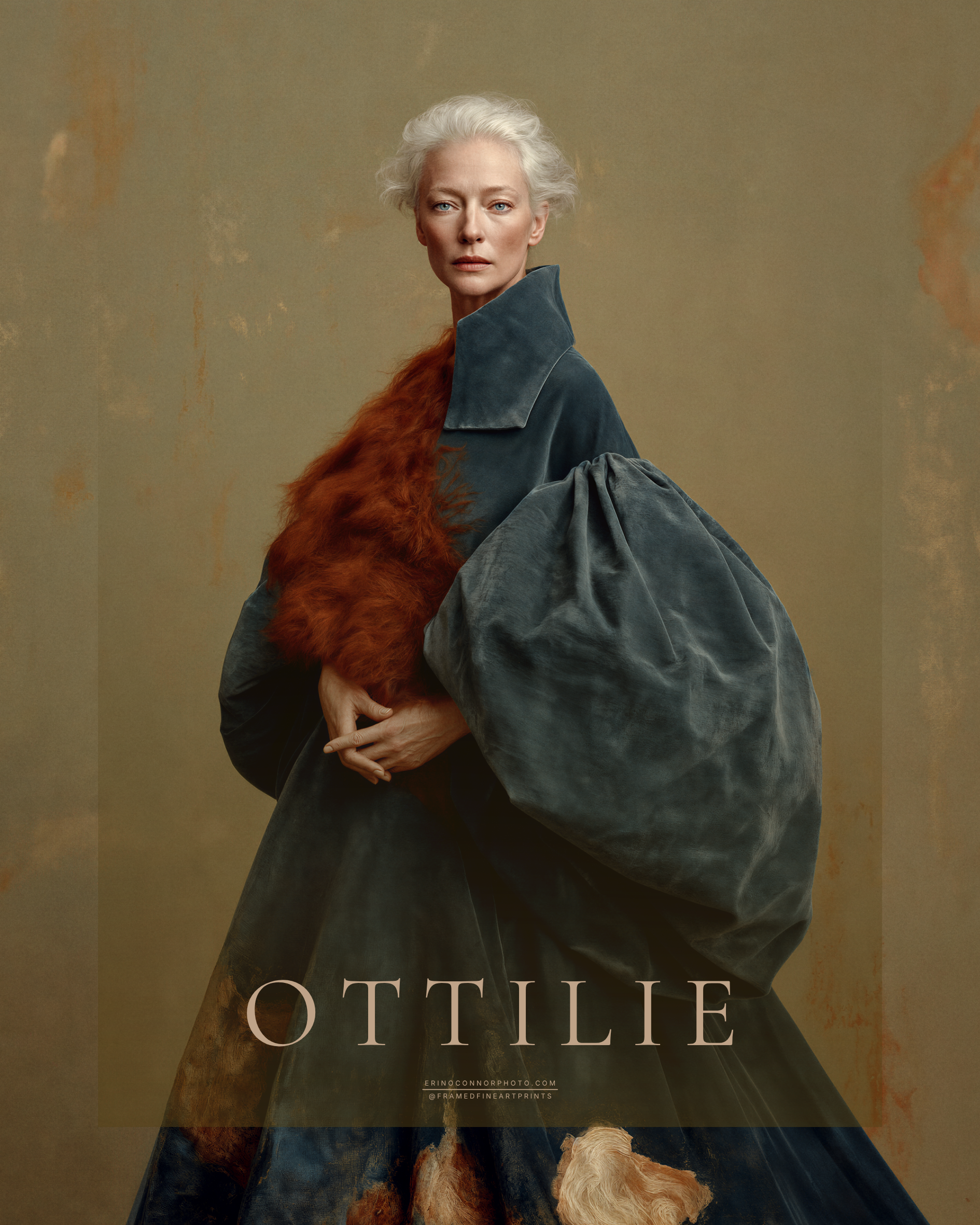 Ottilie fine art portrait of a silver-haired woman wearing a sculptural deep teal garment with rust-colored textile accents against a warm neutral background.