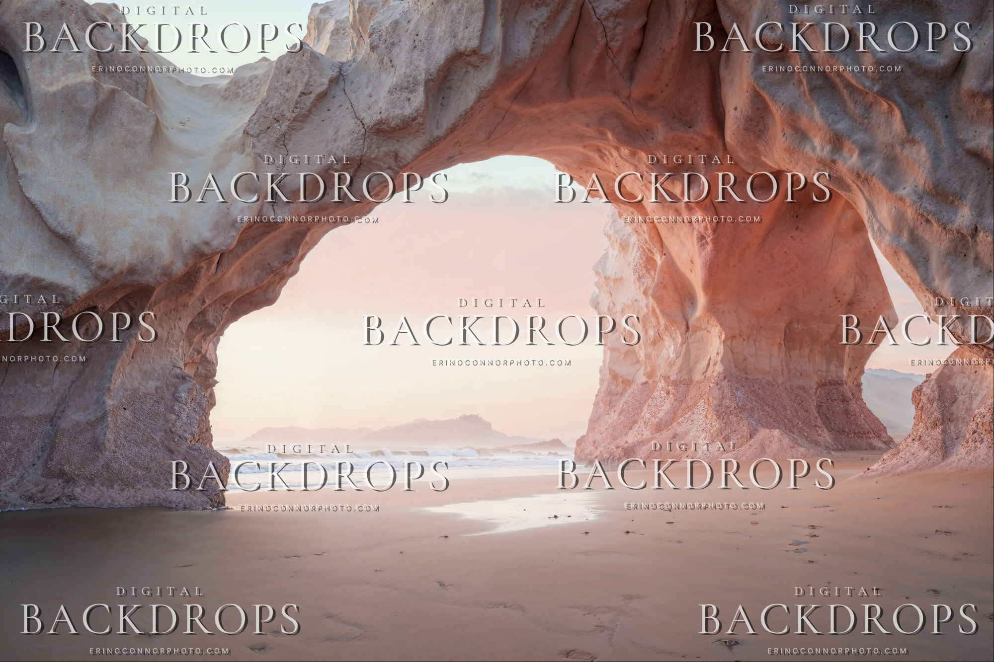 Sunset Beach Arch Blush Horizon digital backdrop featuring an interior cave style beach arch framing the shoreline, soft sunrise glow, blush sand, and ocean horizon.