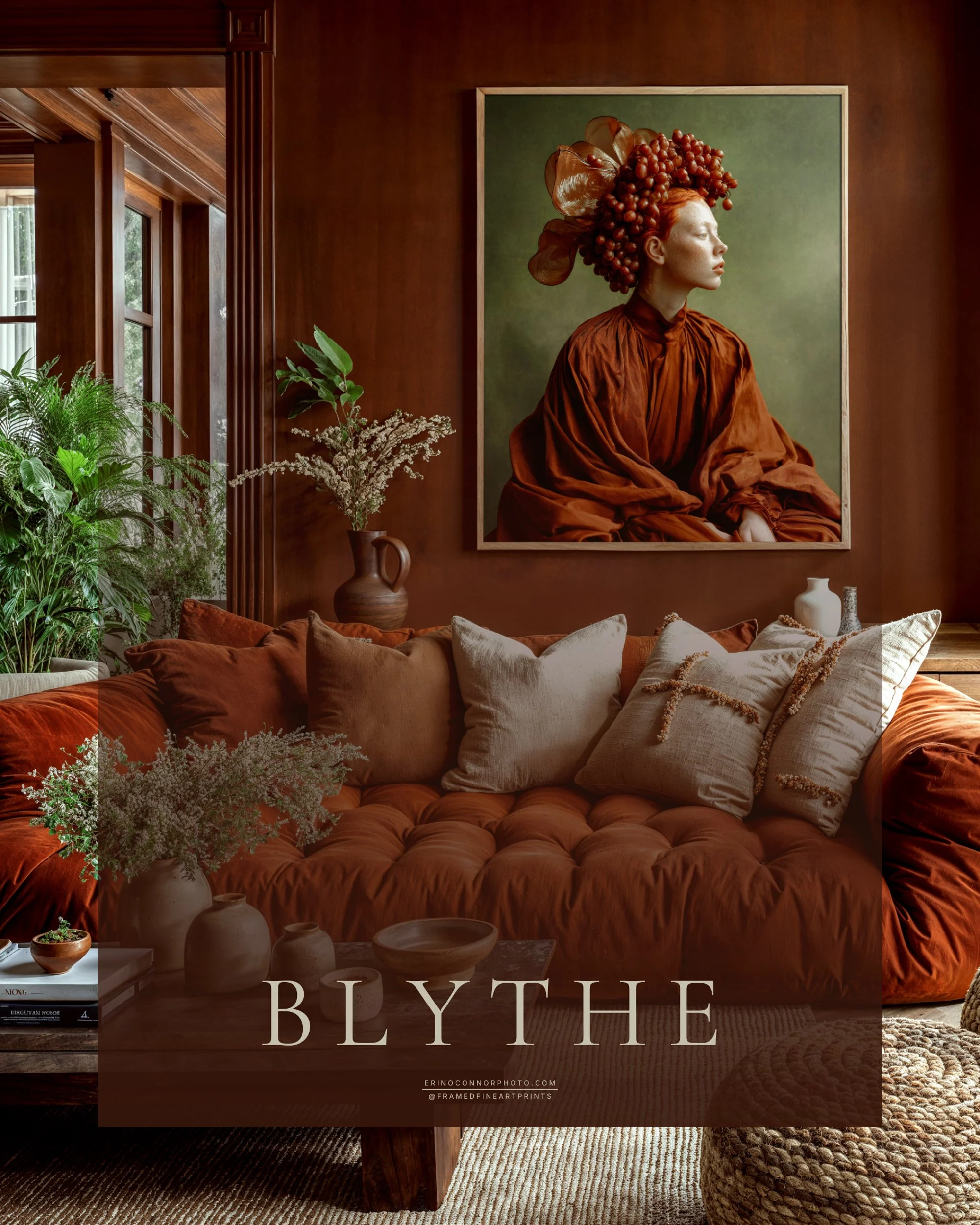 Large framed Blythe fine art portrait displayed above a rust-colored sofa in a warm earth-toned living room.