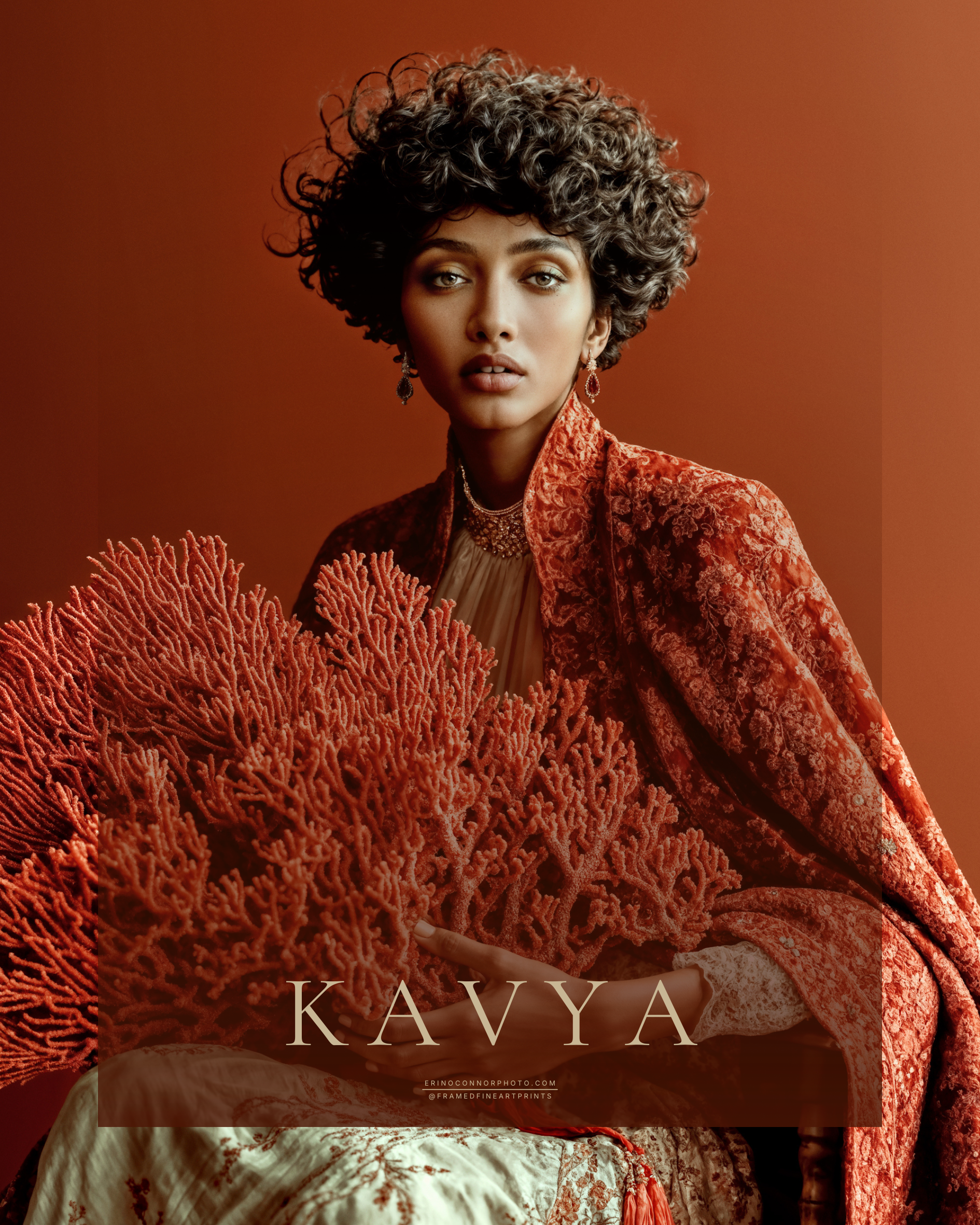 Kavya fine art portrait of a seated woman in red brocade holding a large branching formation of red coral.