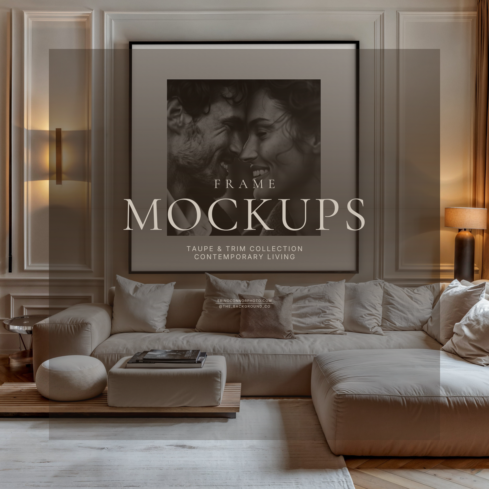 Modern classic room mockup with large black framed print and wide white mat centered above beige sectional, wall panel molding, warm lighting, curtains, styled neutral interior for artwork.