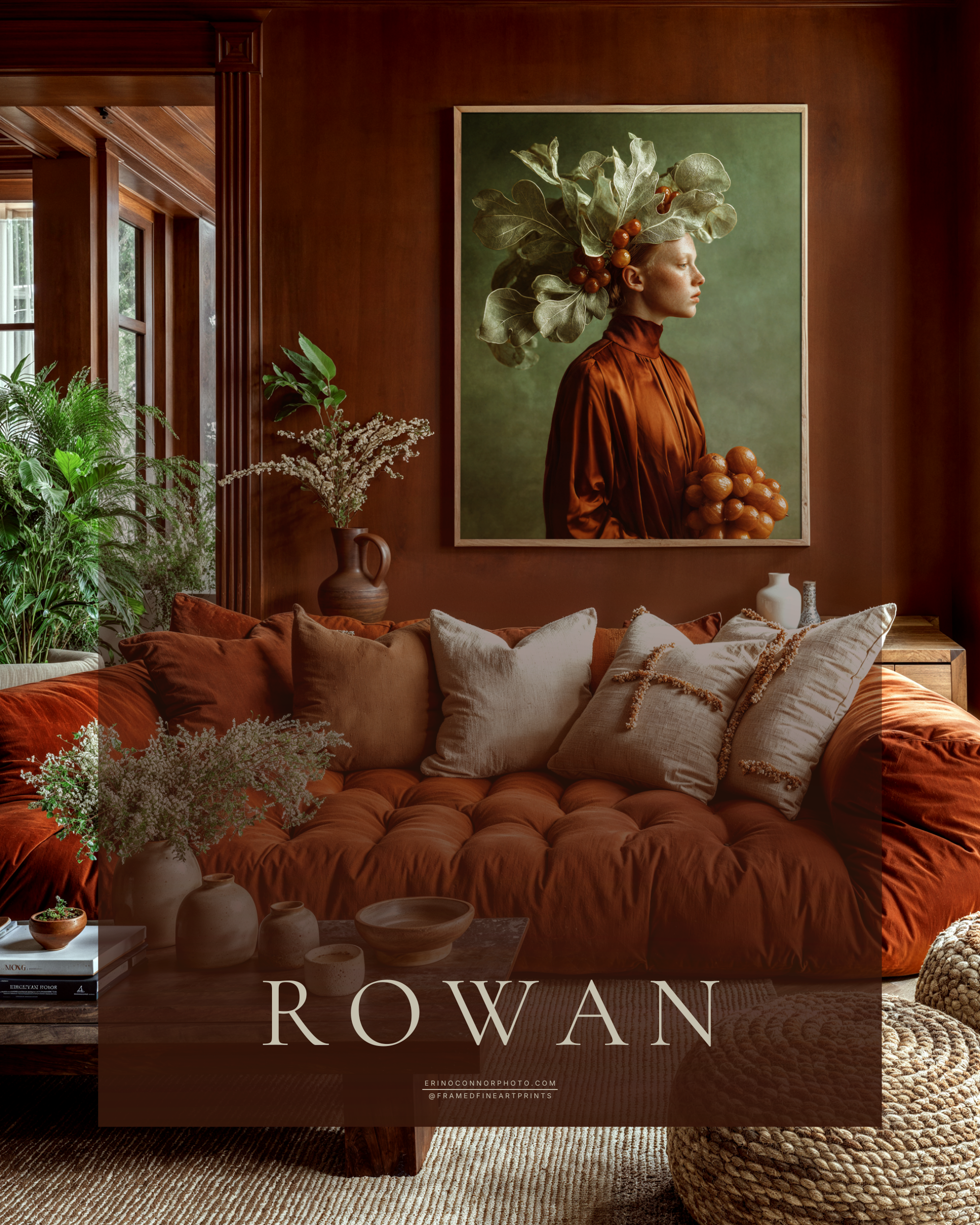 Large framed Rowan fine art portrait displayed above a rust-colored sofa in a warm wood and earth-toned living room.