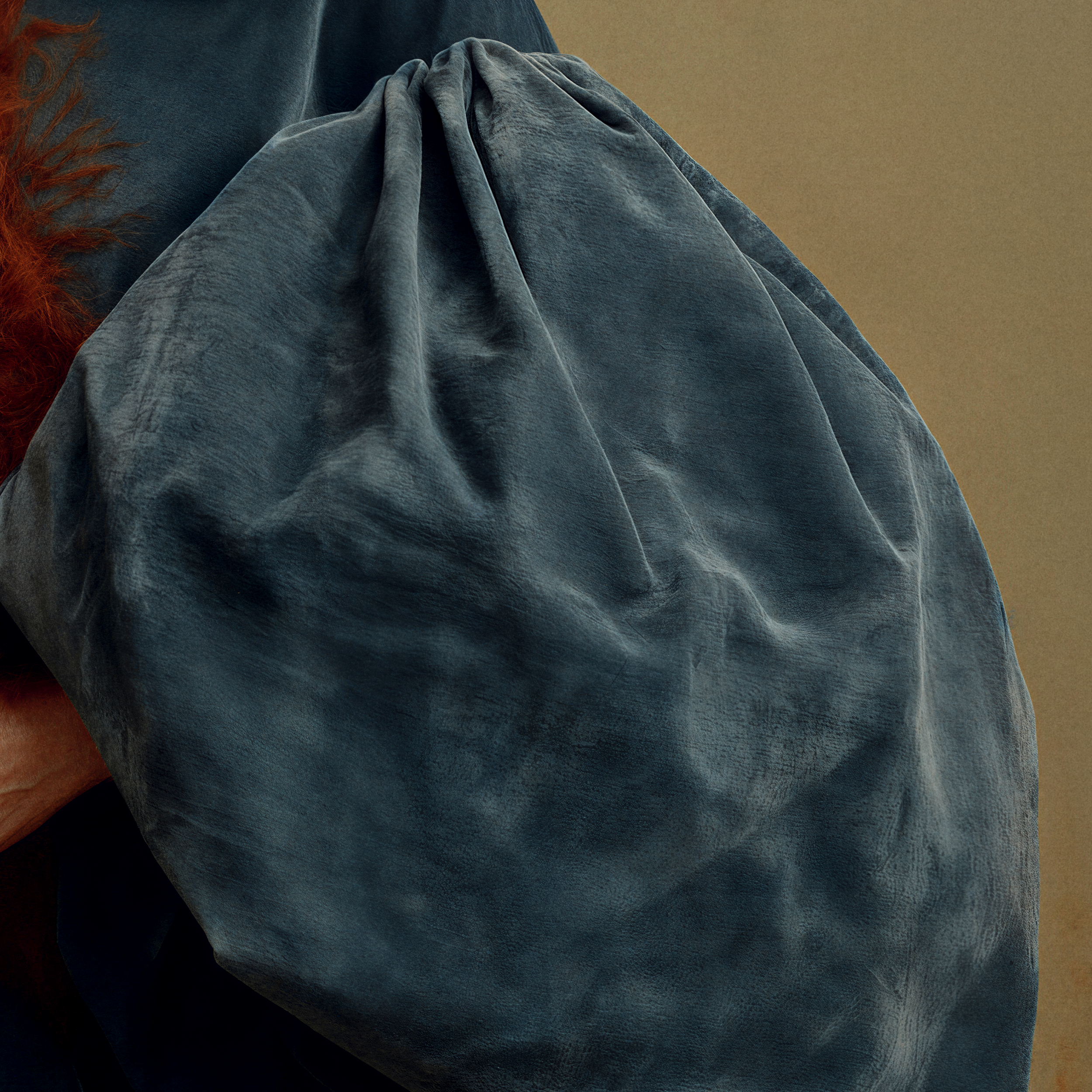 Close-up of the oversized deep teal sleeve in Ottilie, showing soft velvet-like texture, folds, and sculptural volume.