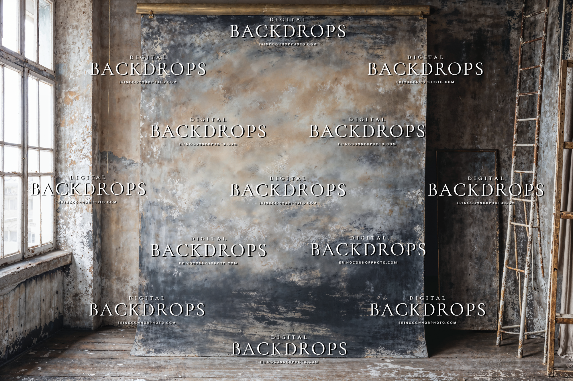 Hand painted canvas style studio backdrop with brass pipe crossbar, warm beige and stormy gray textures, distressed wall, ladder and stool in an industrial photo studio.