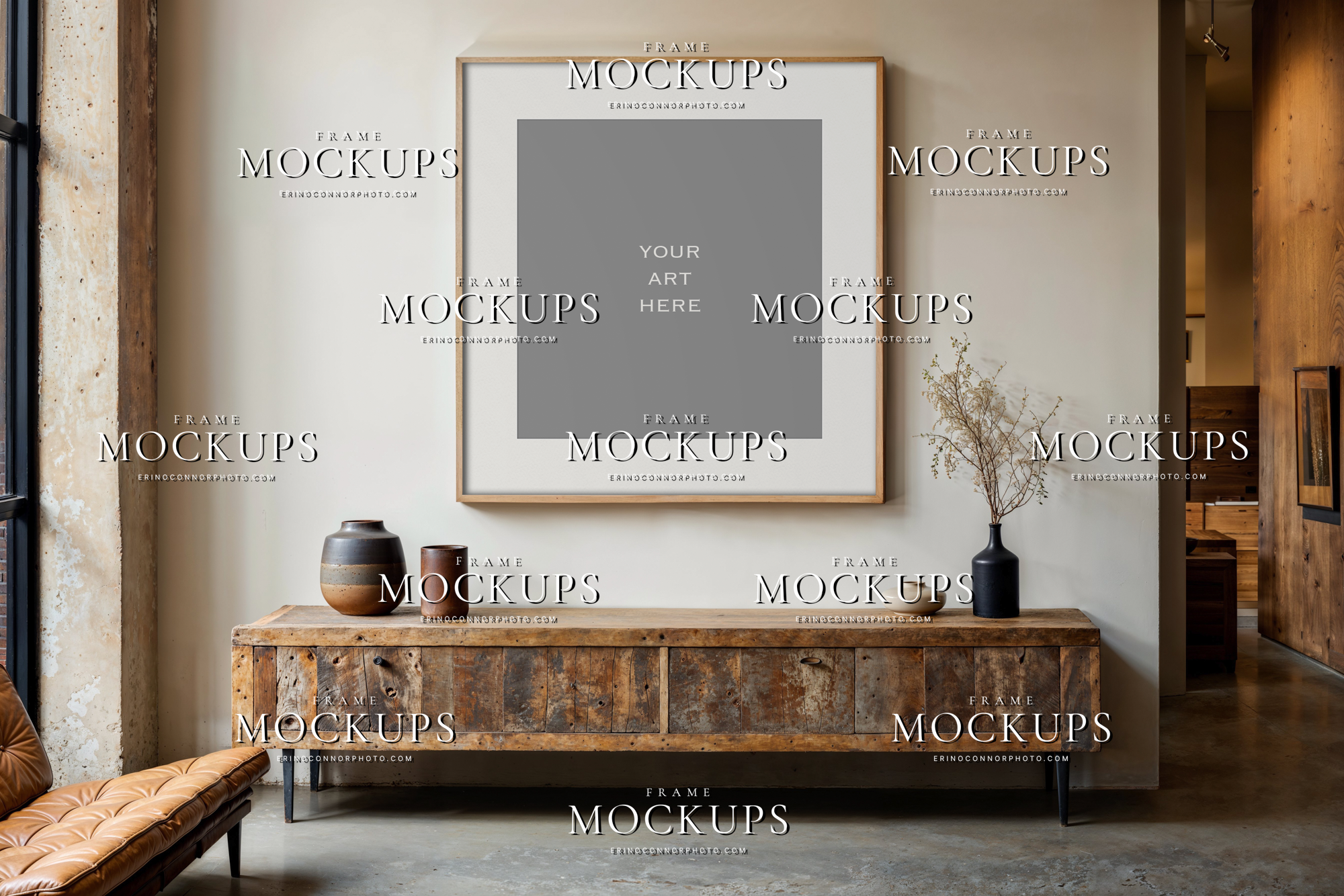 Rustic modern interior frame mockup above a weathered wood console with warm neutral wall, pottery, and minimal organic decor.