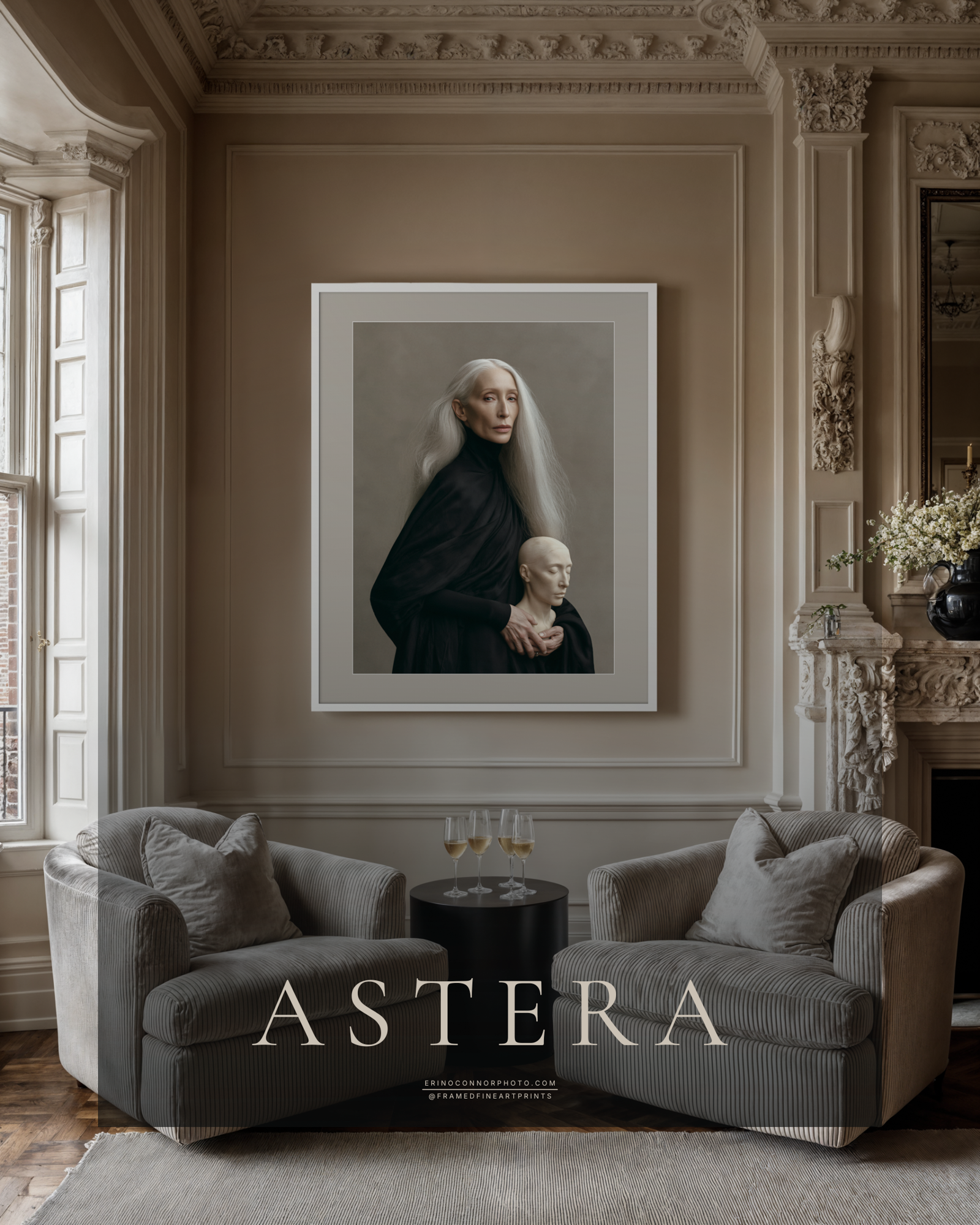 Large framed Astera fine art portrait displayed between two upholstered chairs in an elegant neutral interior with classical architectural details.