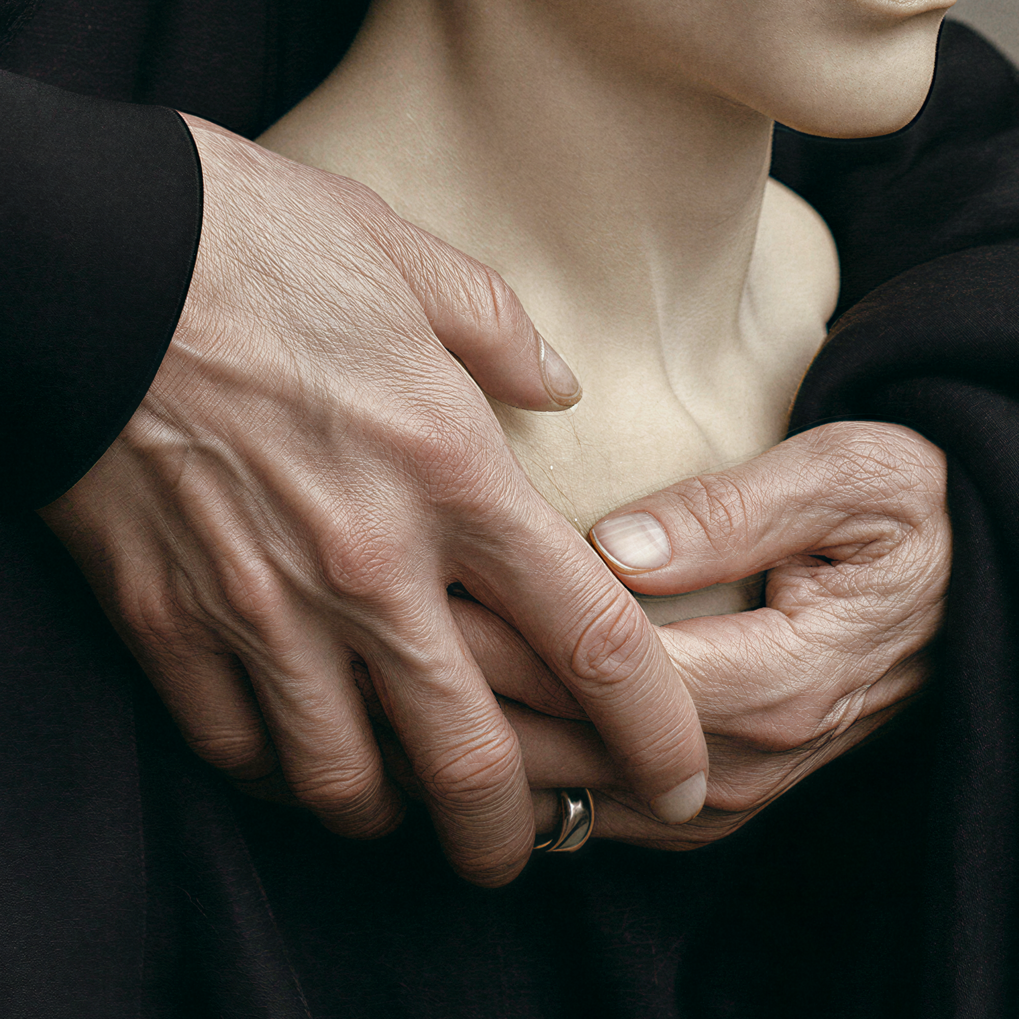 Close detail of Astera's mature hands gently surrounding the pale sculptural likeness.