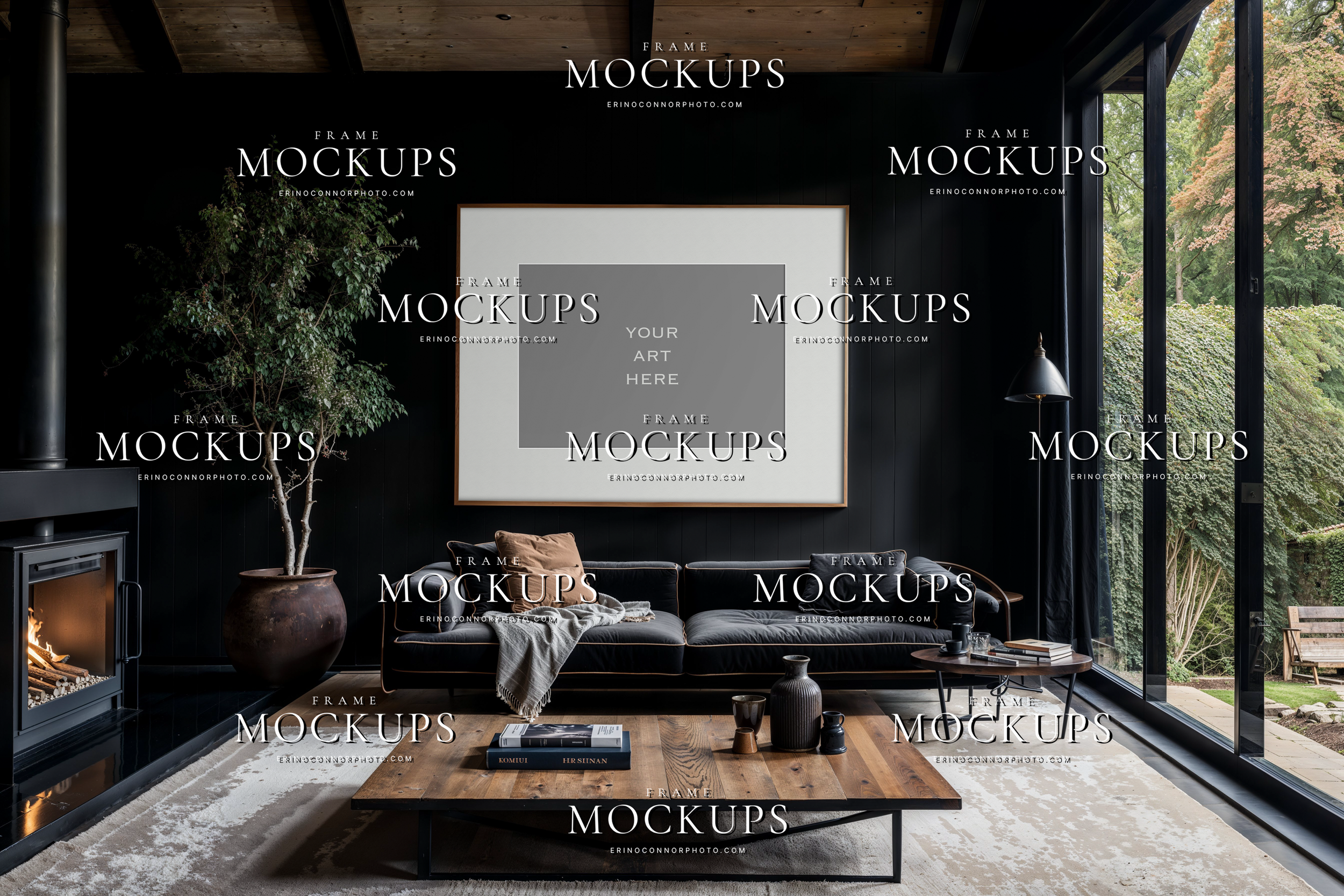 Modern rustic clean wall art mockup with tall portrait frame above a black fireplace, dark sectional, wood ceiling, and large windows in a moody rustic room.
