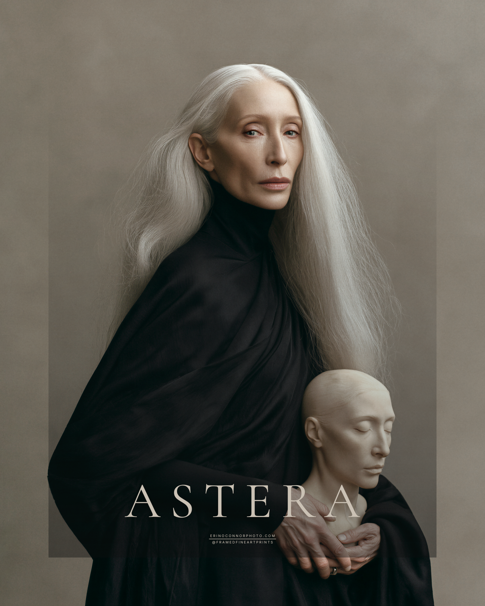 Astera fine art portrait of a silver-haired older woman in black holding a pale sculptural likeness with closed eyes.