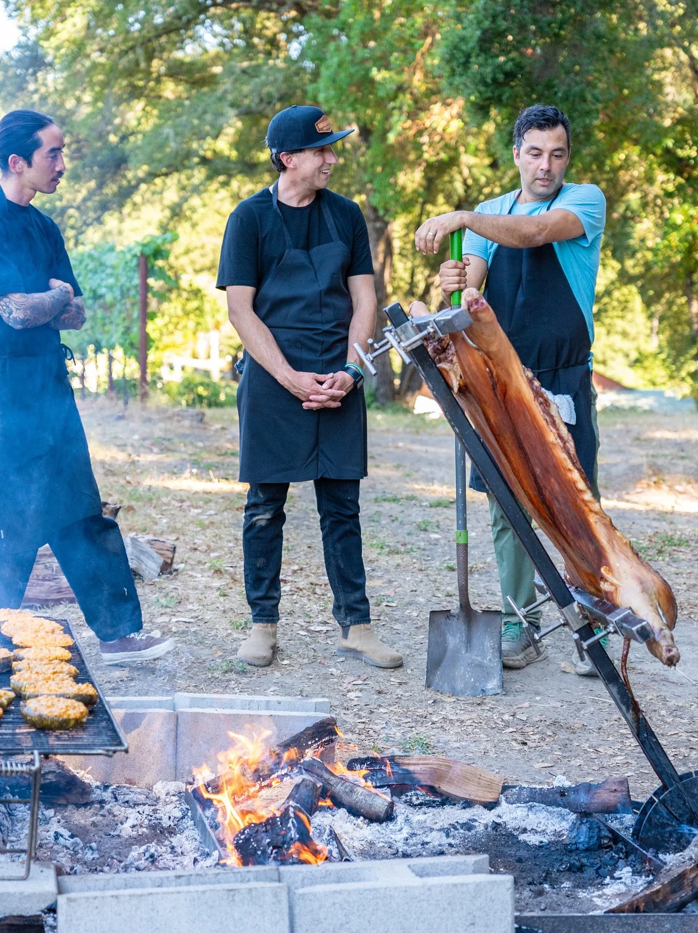 Chef tending an open fire for a Colectivo Felix five-course tasting menu in the Santa Cruz Mountains