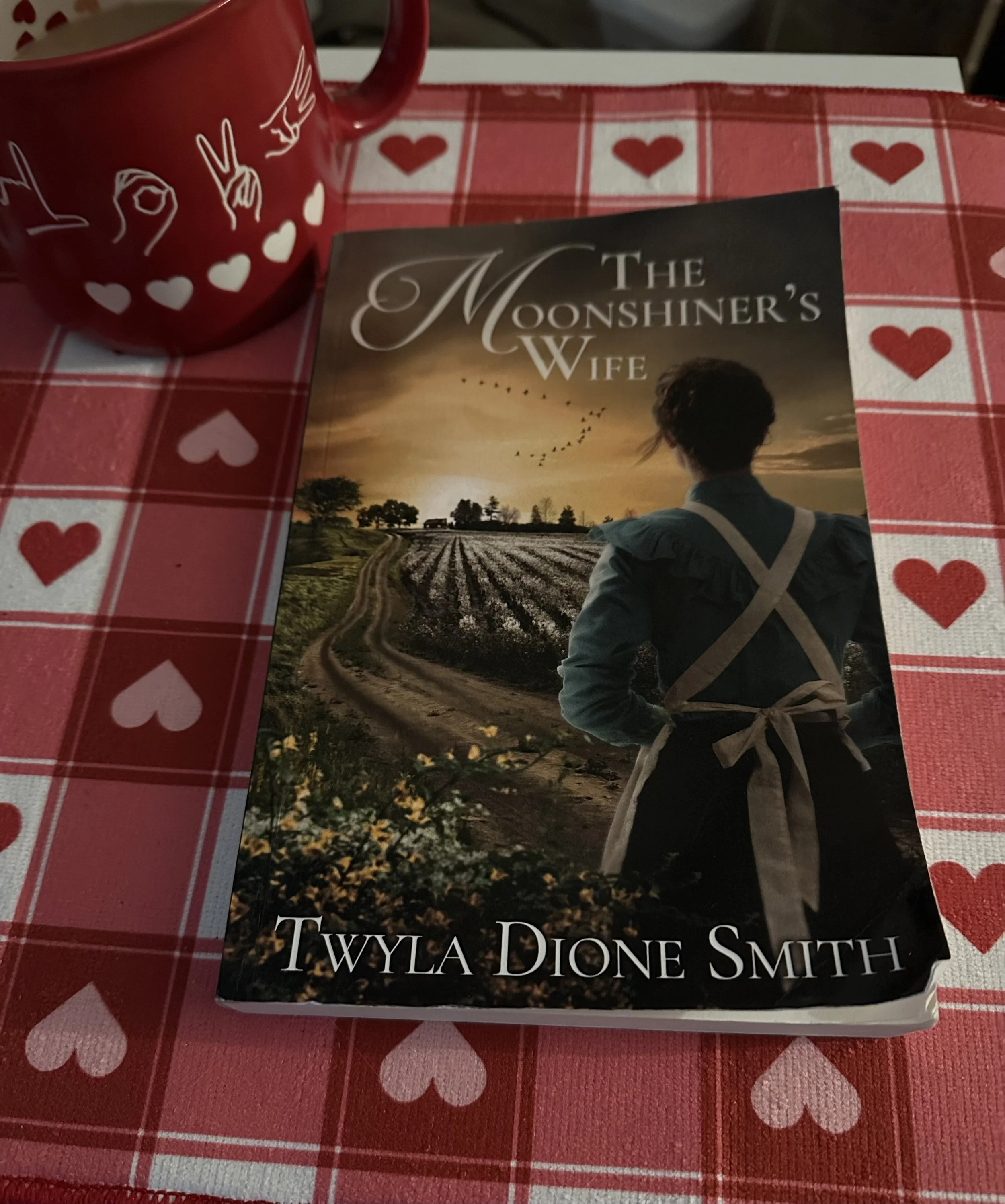      

 
    Book Review:  The Moonshiner’s Wife  by Twyla Dione Smith    The Moonshiner’s Wife  marks an impressive debut for Twyla Dione Smith, a real estate agent turned historical fiction author. From the first pages, it’s clear that this story i