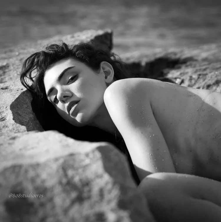 Photographer using low-angle camera technique in a boudoir shoot