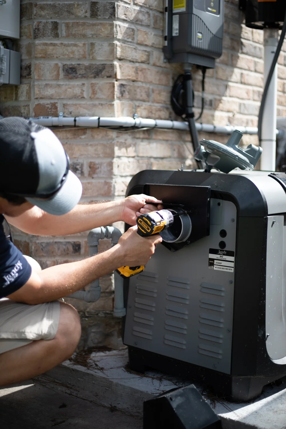 Peppermint technician servicing a Jandy pool heater