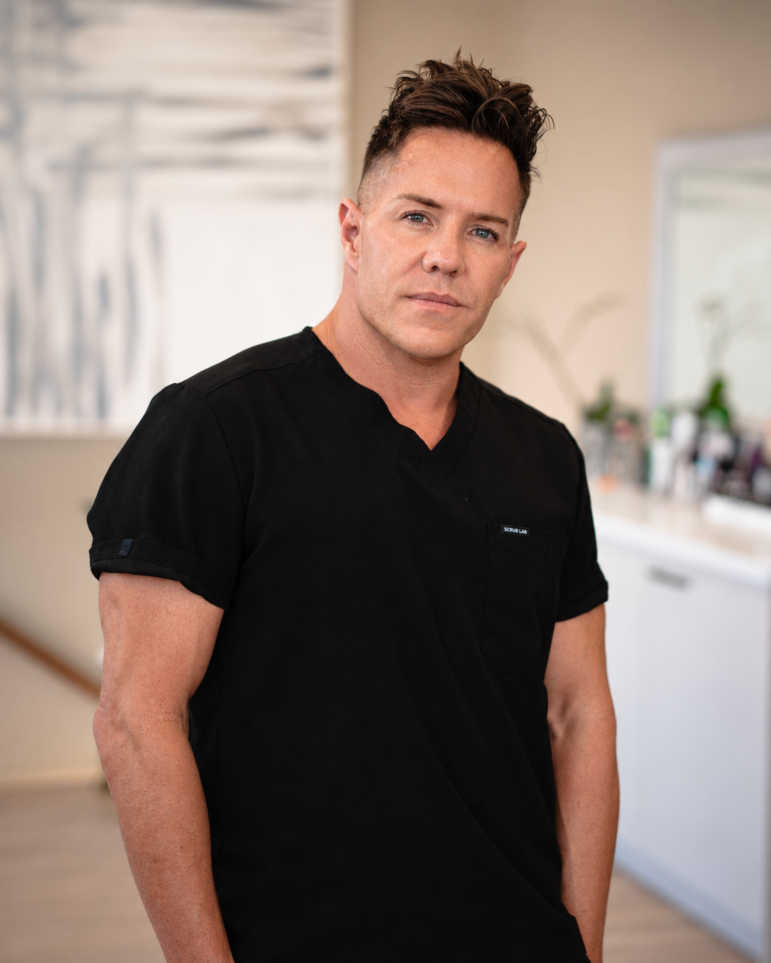 Person wearing black "Platinum Cosmetics" t-shirt