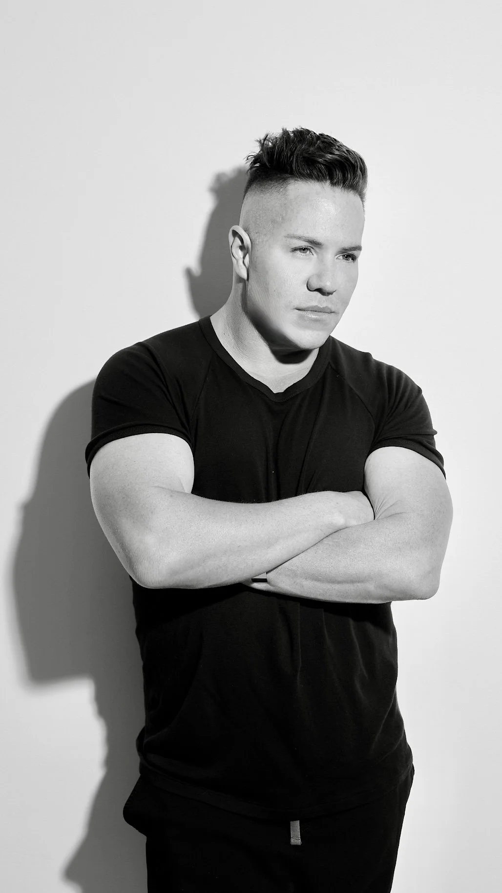 Person wearing black "Platinum Cosmetics" t-shirt